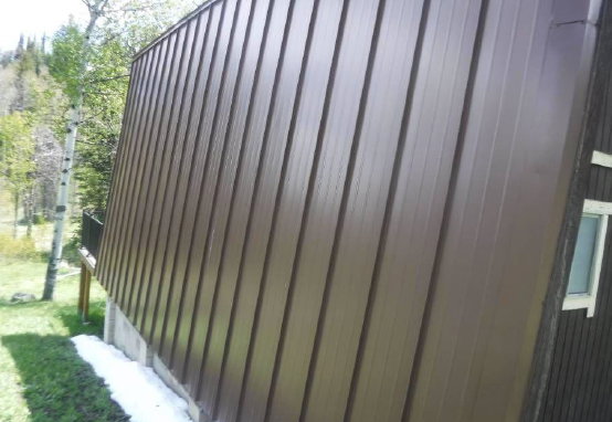 Vertical brown metal siding with a prominent A-frame architectural style