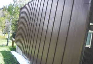 Vertical brown metal siding with a prominent A-frame architectural style