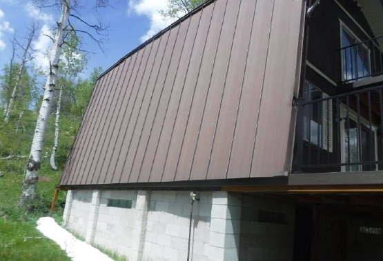 A-frame structure featuring a brown metal roof