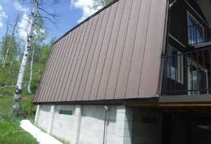 A-frame structure featuring a brown metal roof