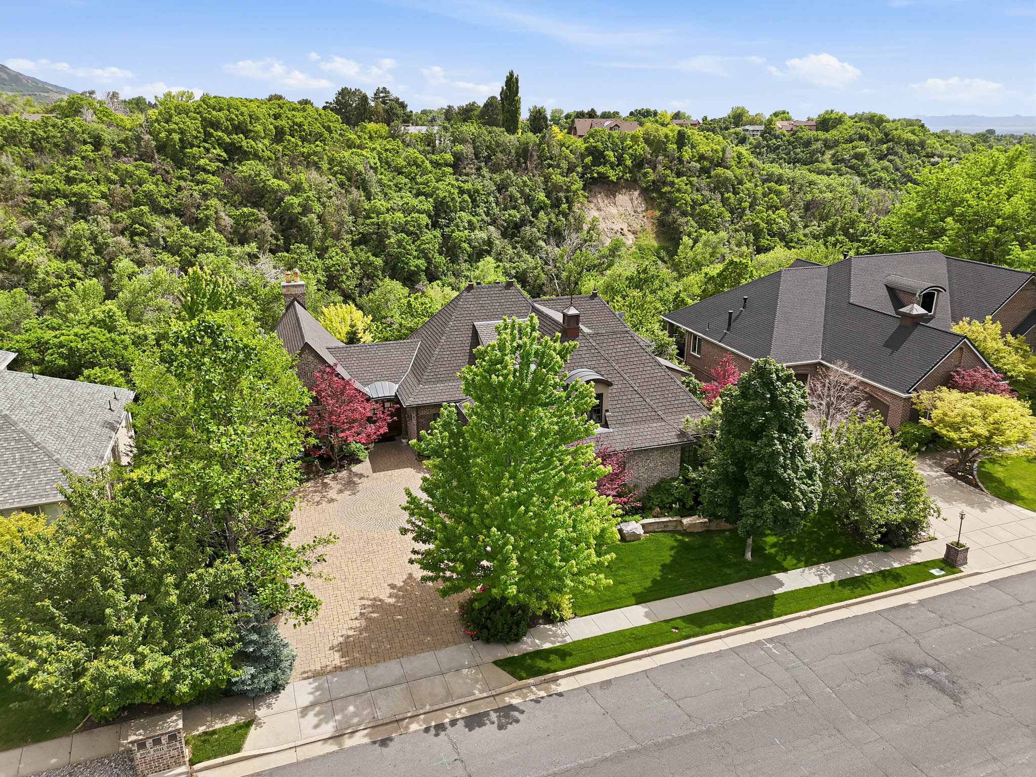 Brick exterior residence featuring a multi-gabled roofline and an attached garage
