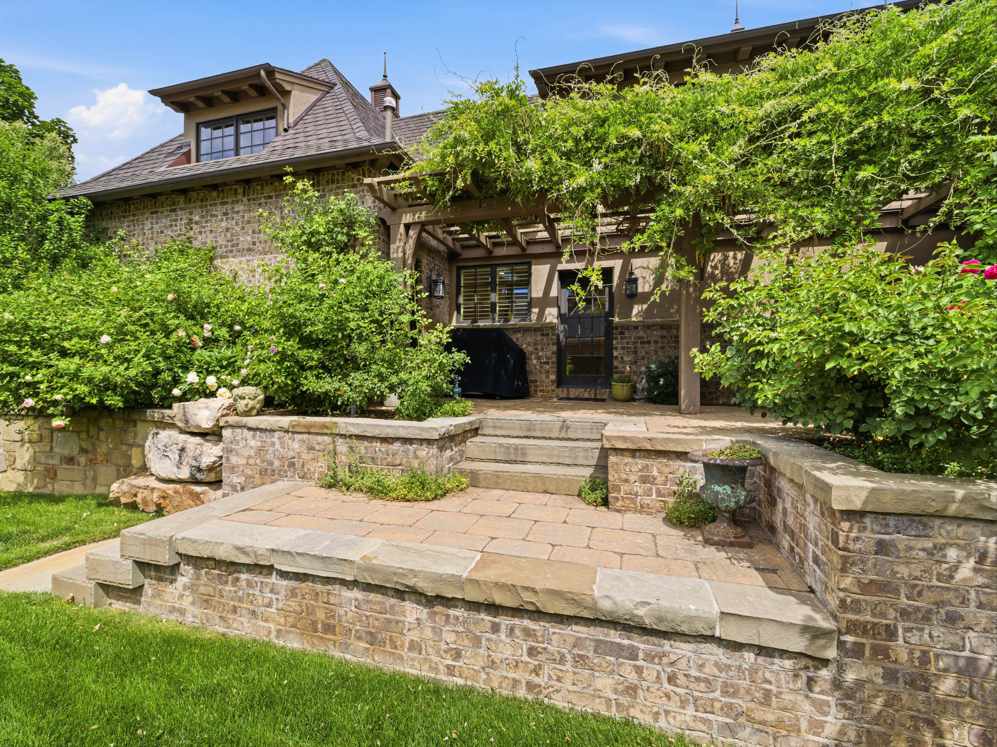 Brick exterior with stone accents and a prominent dormer window