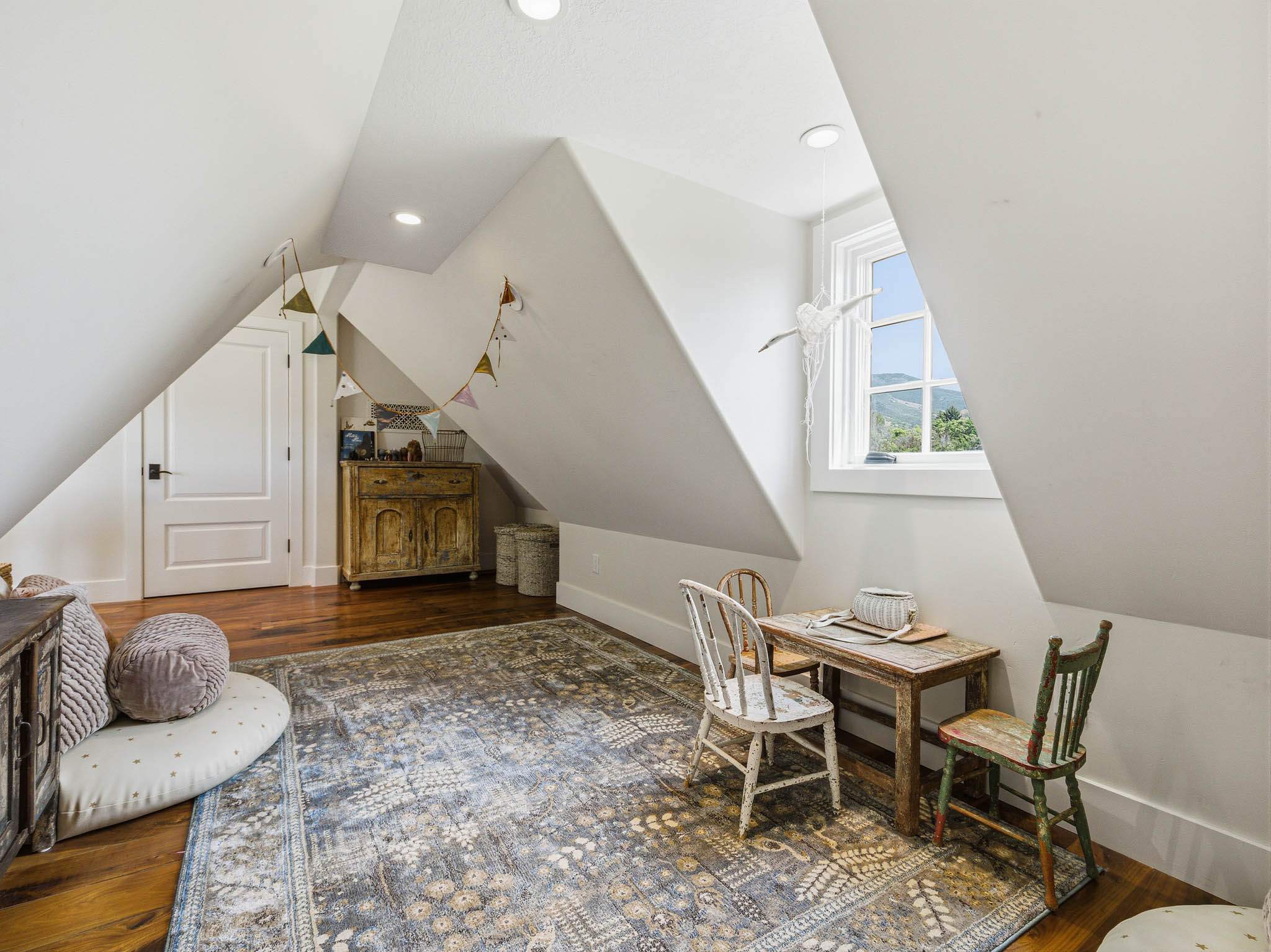 Attic space featuring sloped ceilings, recessed lighting, and wood-finish flooring