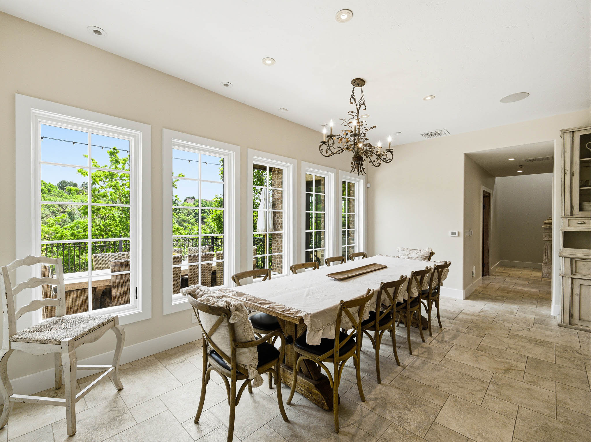 Dining area featuring multiple windows, recessed lighting, and a decorative chandelier