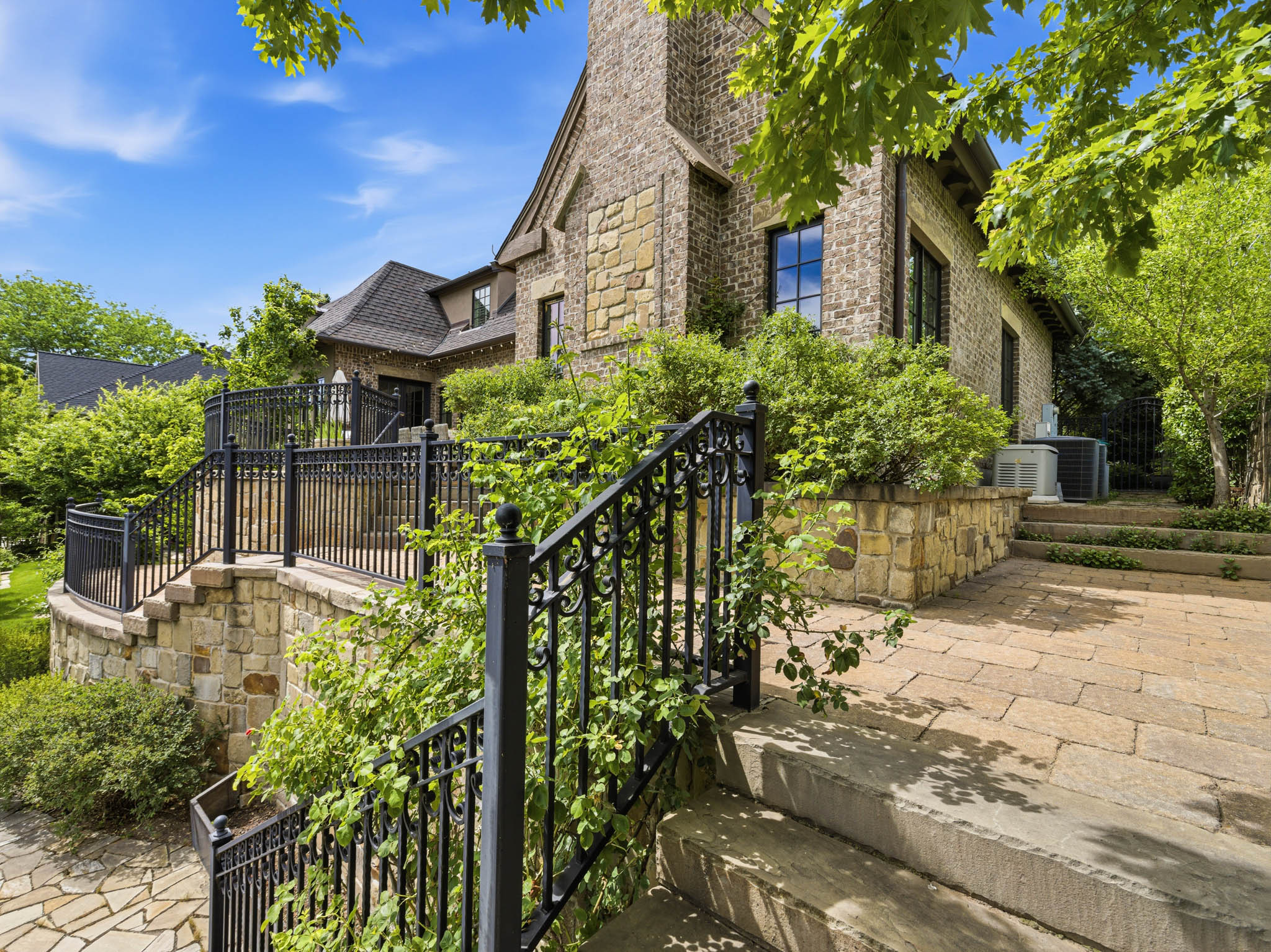 Stone exterior with decorative black iron railings