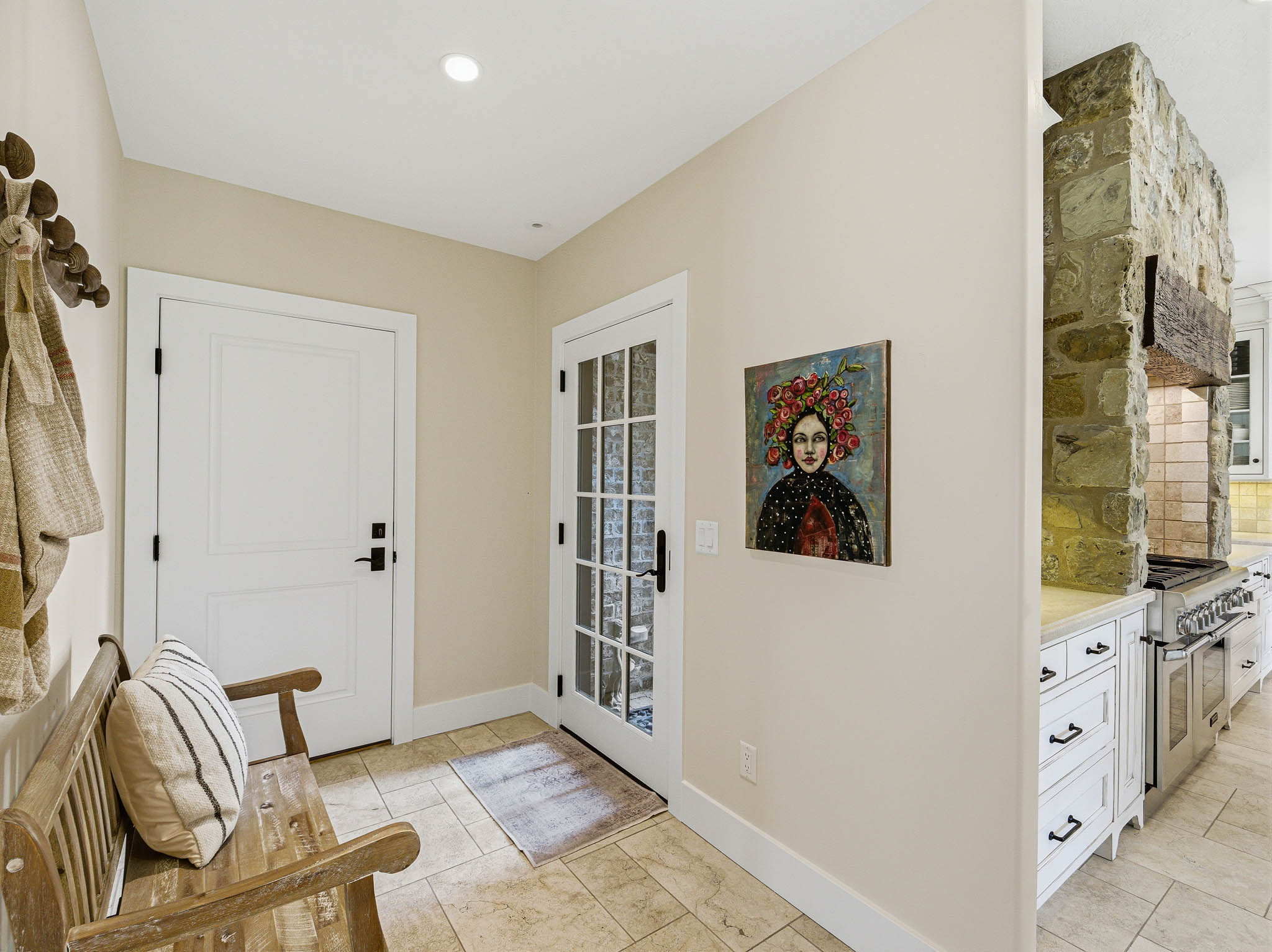 Entryway featuring tile flooring, recessed lighting, a solid white door, and a French door with multiple glass panes