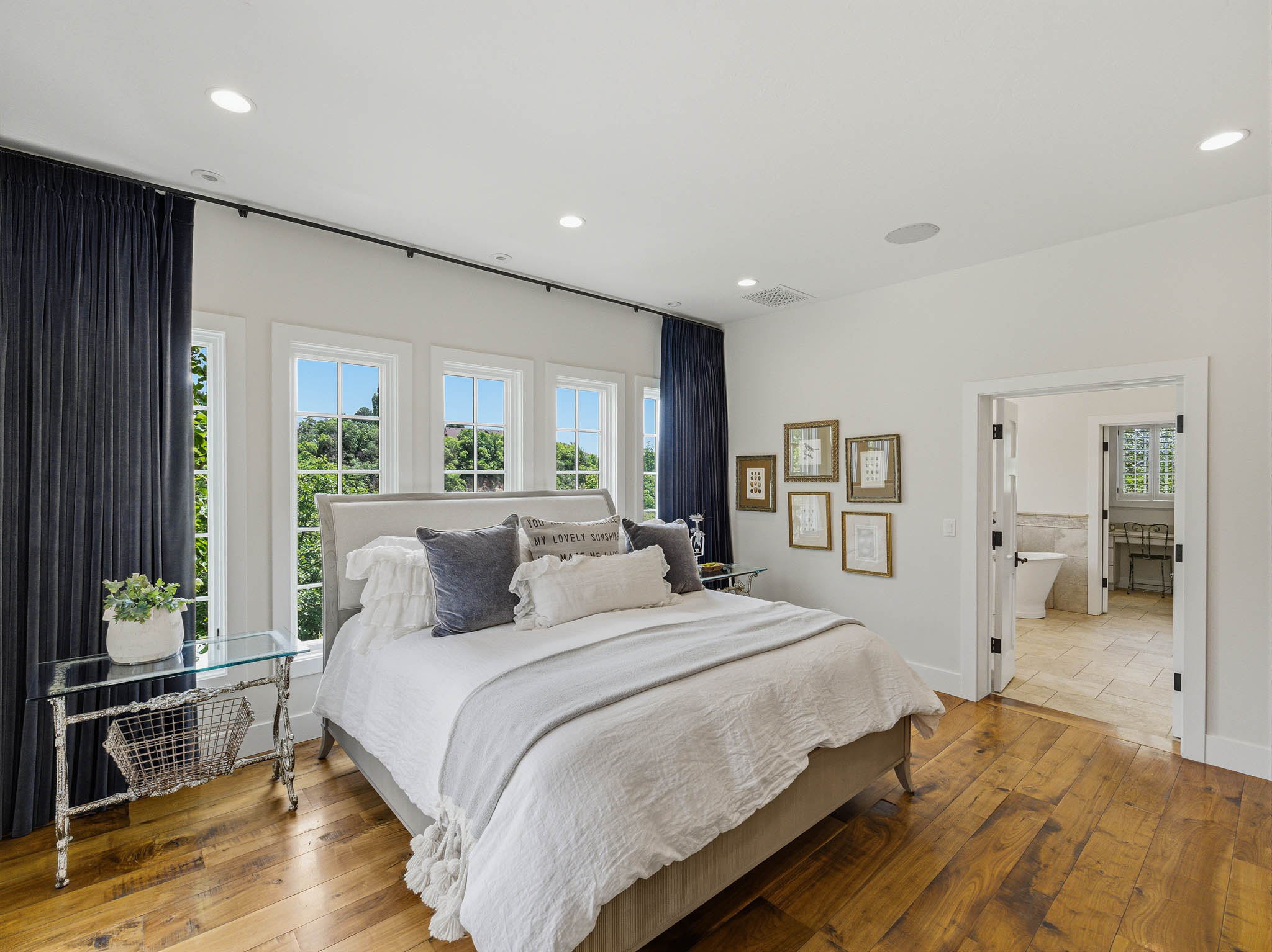 Bedroom with extensive natural hardwood flooring and recessed ceiling lighting