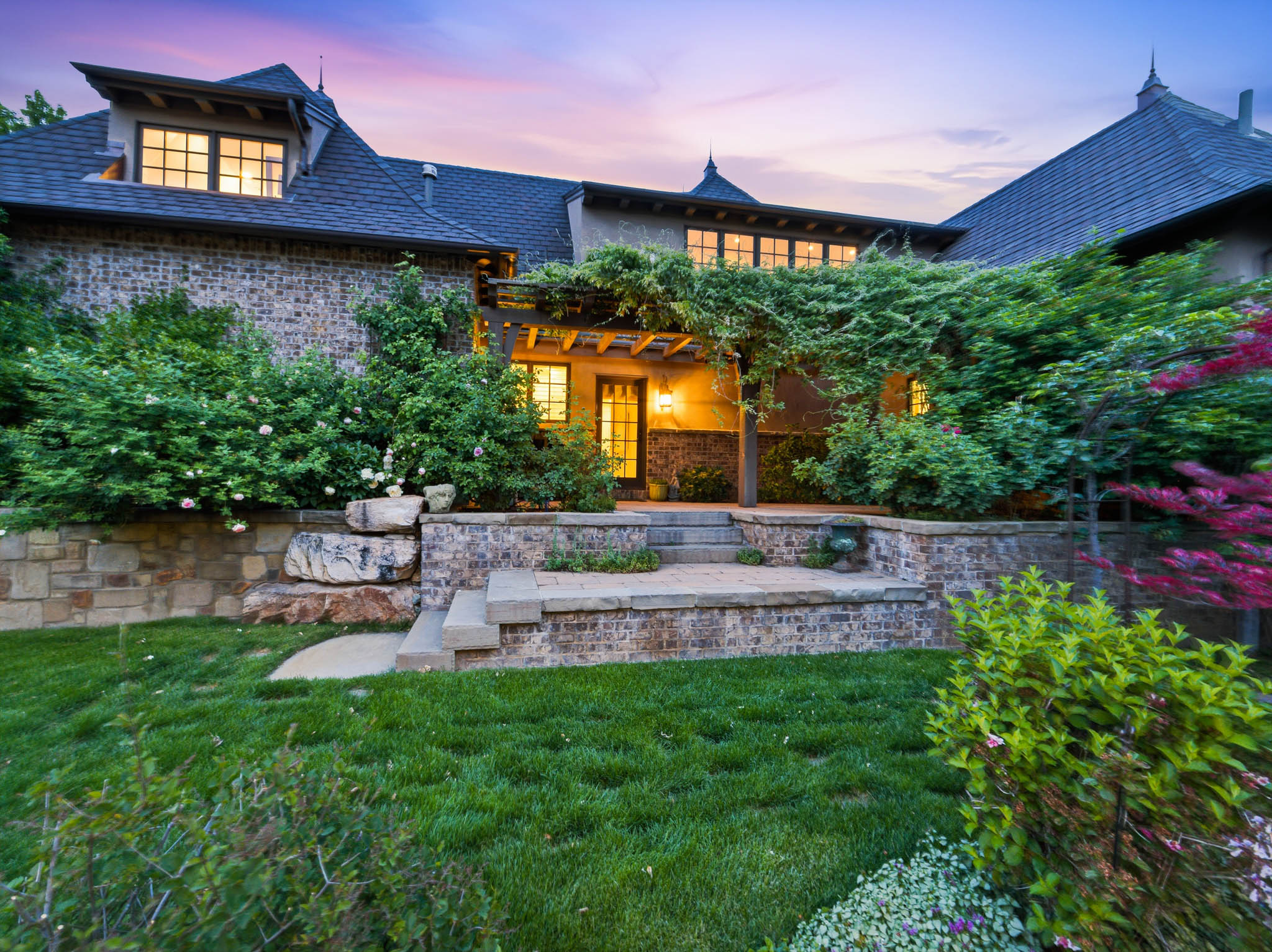 Tiered backyard patio with stone retaining walls and steps