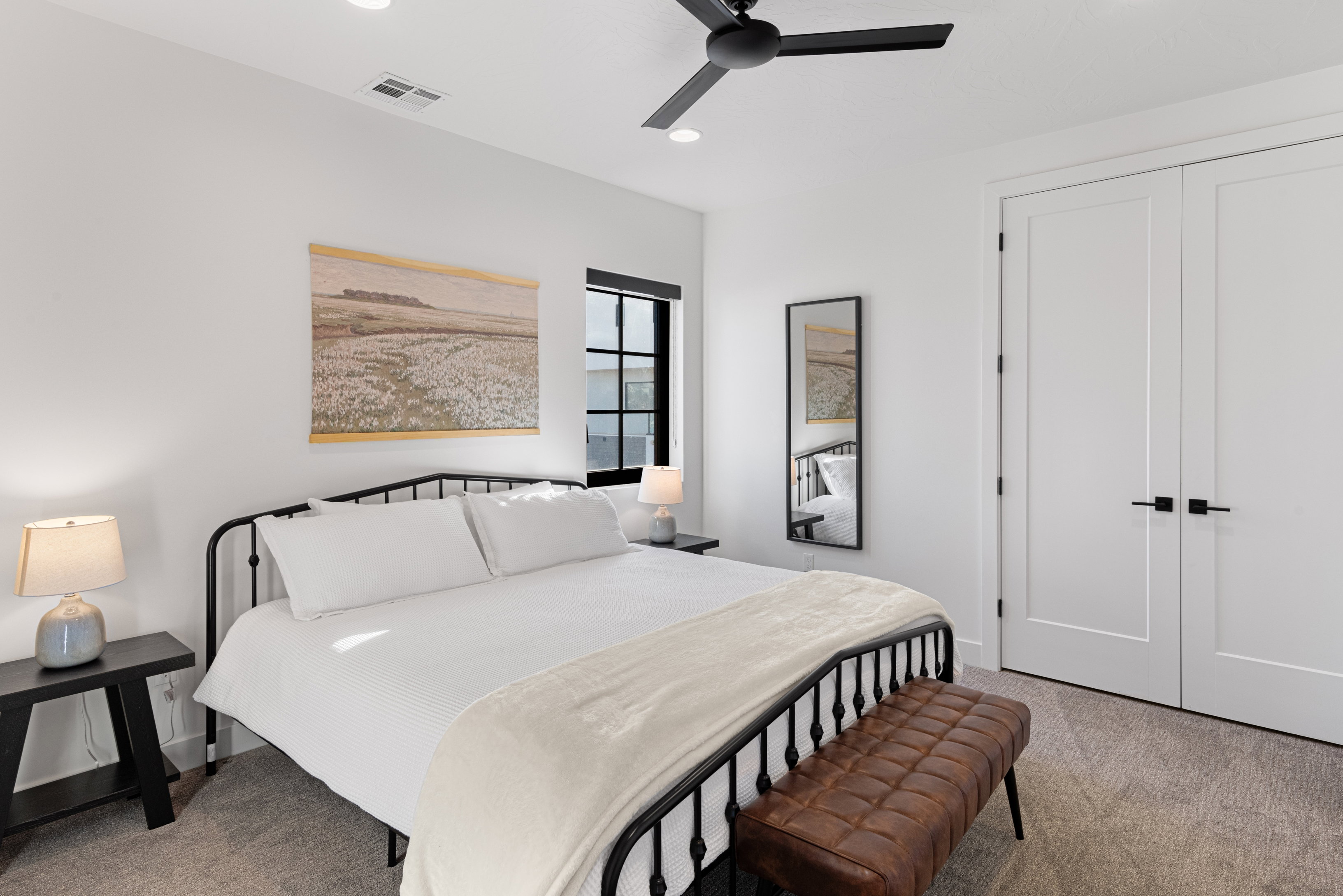 Neutral interior featuring a matte black ceiling fan, recessed lighting, and a window with black trim