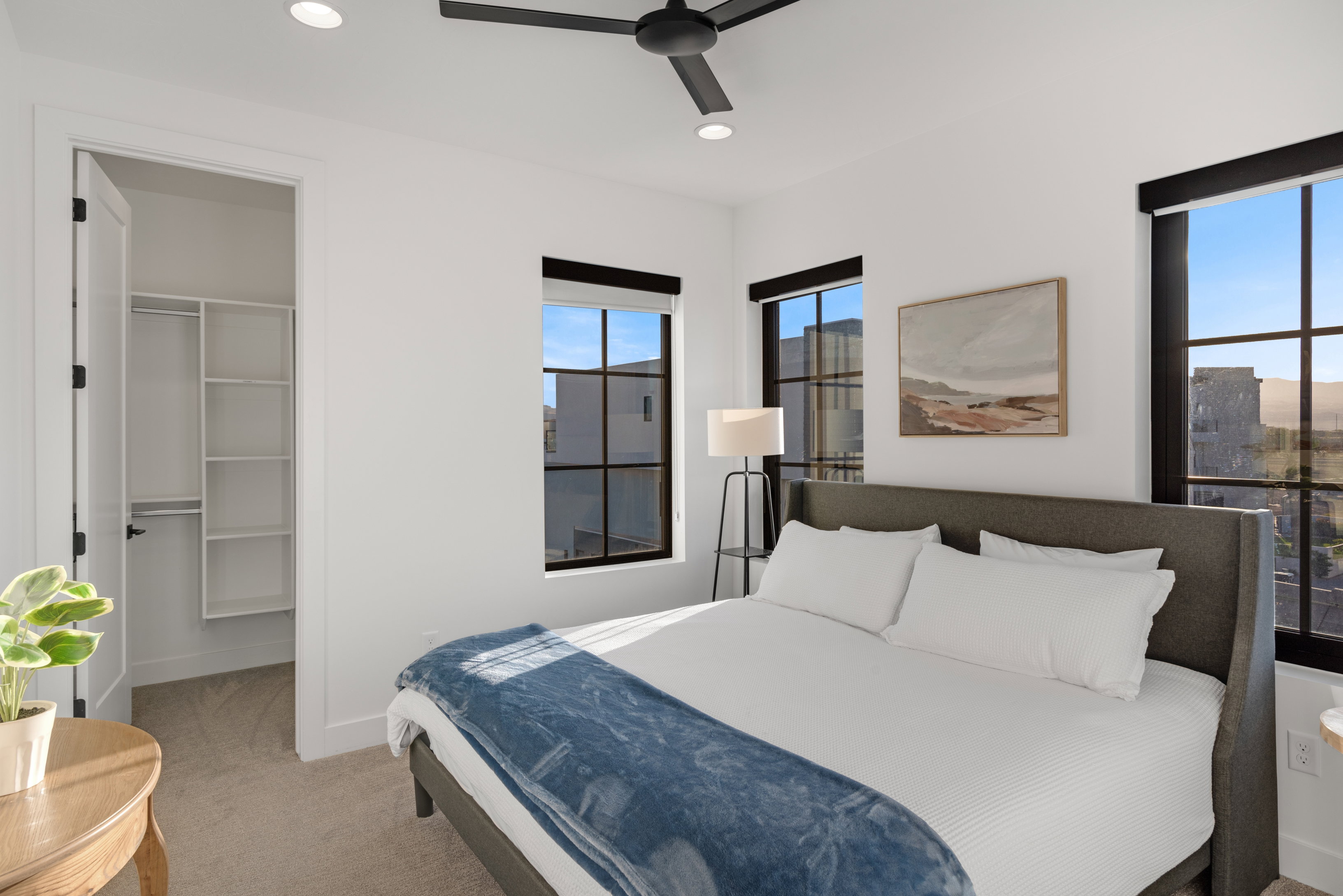 Bedroom featuring ample natural light from multiple windows, a ceiling fan, recessed lighting, and a closet with built-in shelving