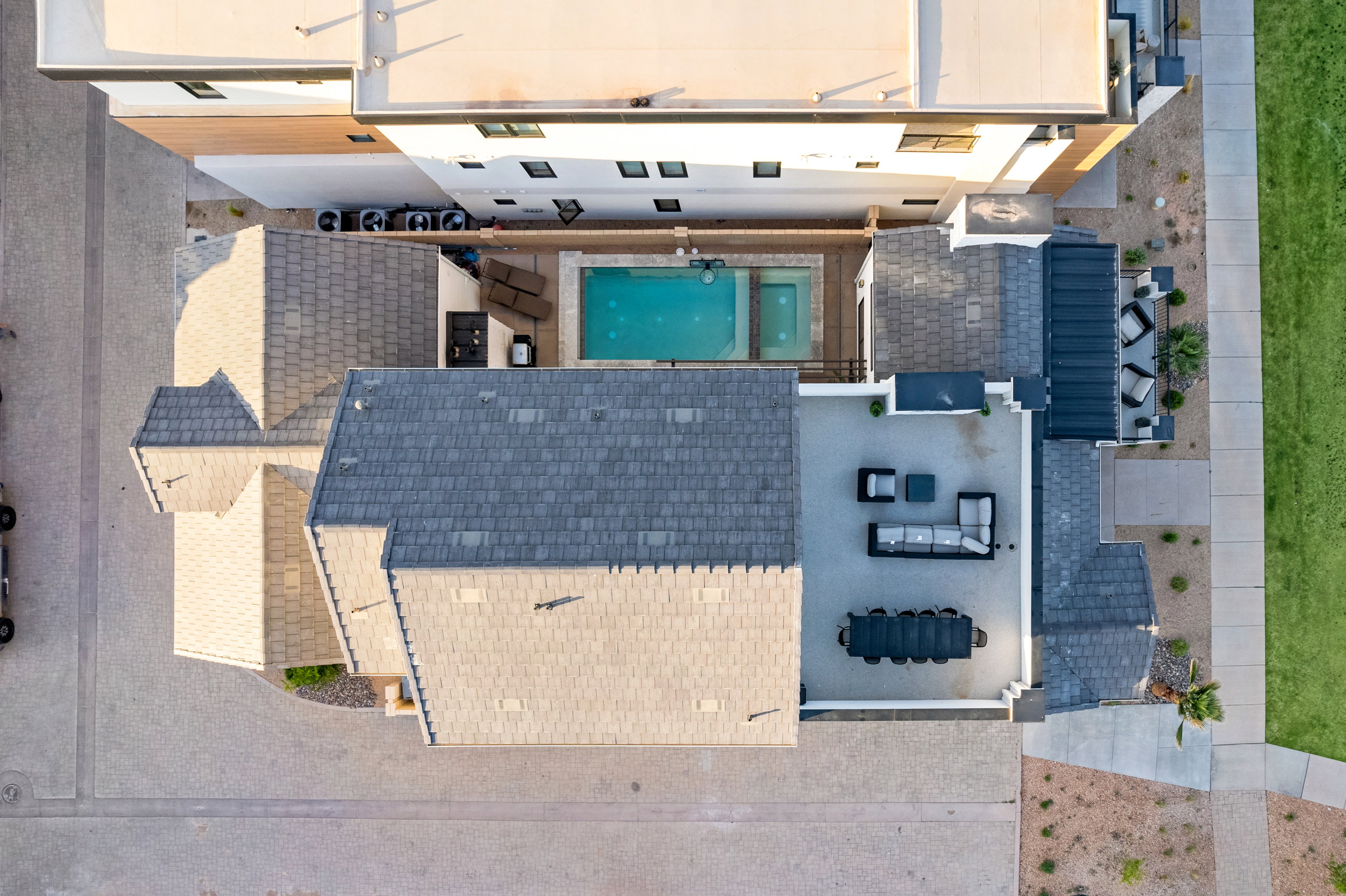 Aerial perspective showcasing a property with multiple rooflines and an outdoor entertaining area