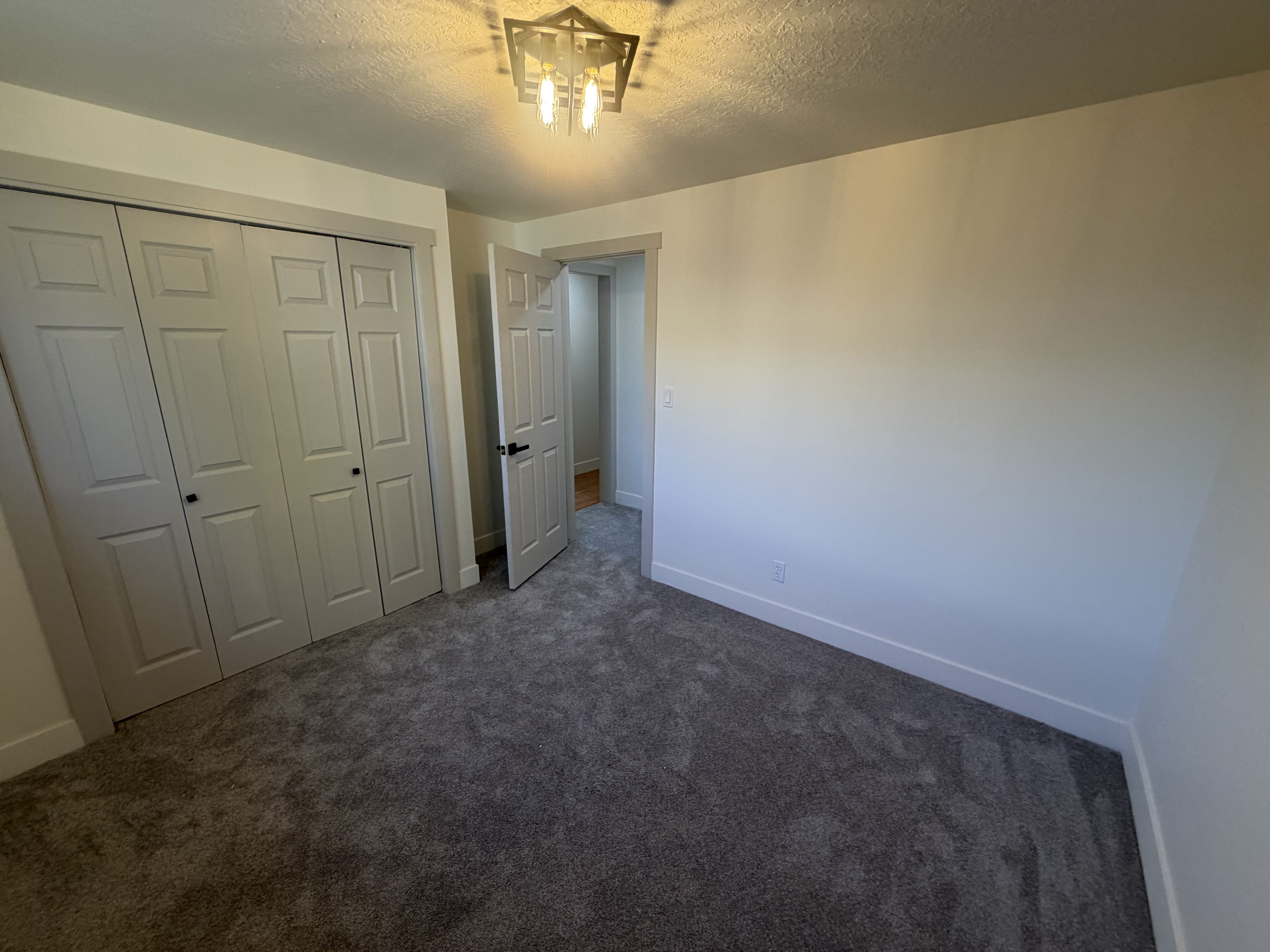 Bedroom 2. Bedroom featuring plush gray carpeting, white walls, and white baseboards