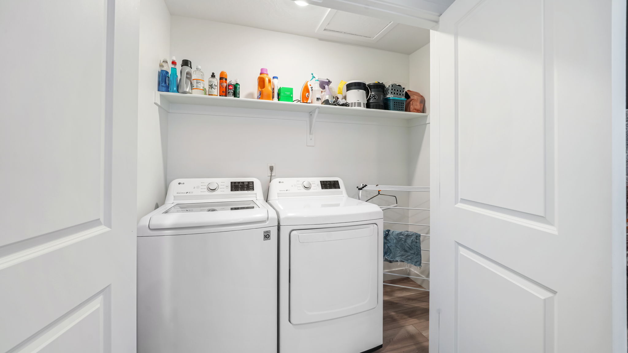 Dedicated laundry area featuring white appliances, a top-loading washing machine, and a front-loading dryer