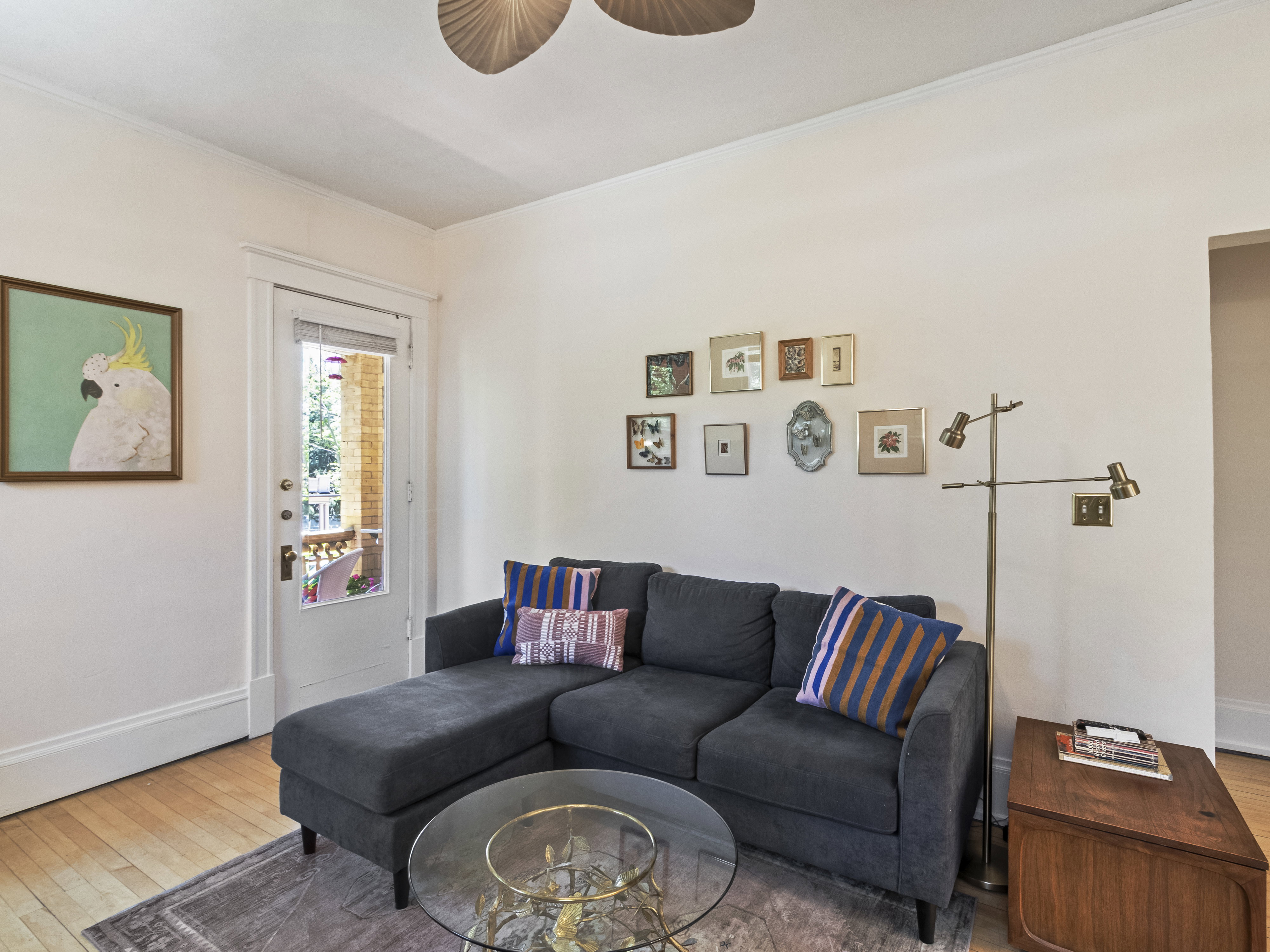 Light wood-finish flooring with white baseboards and crown molding