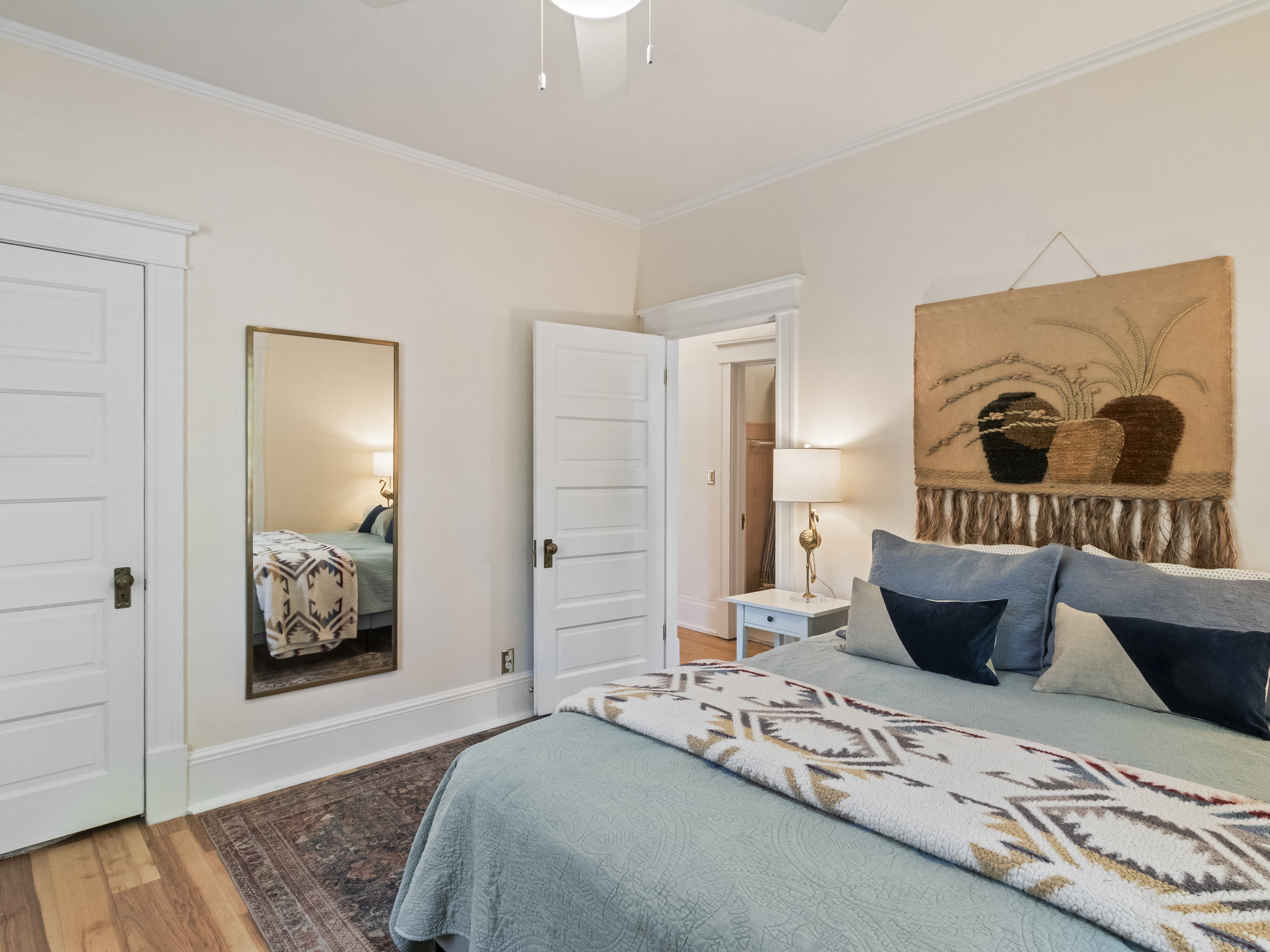 Hardwood flooring complements the neutral wall color and white trim