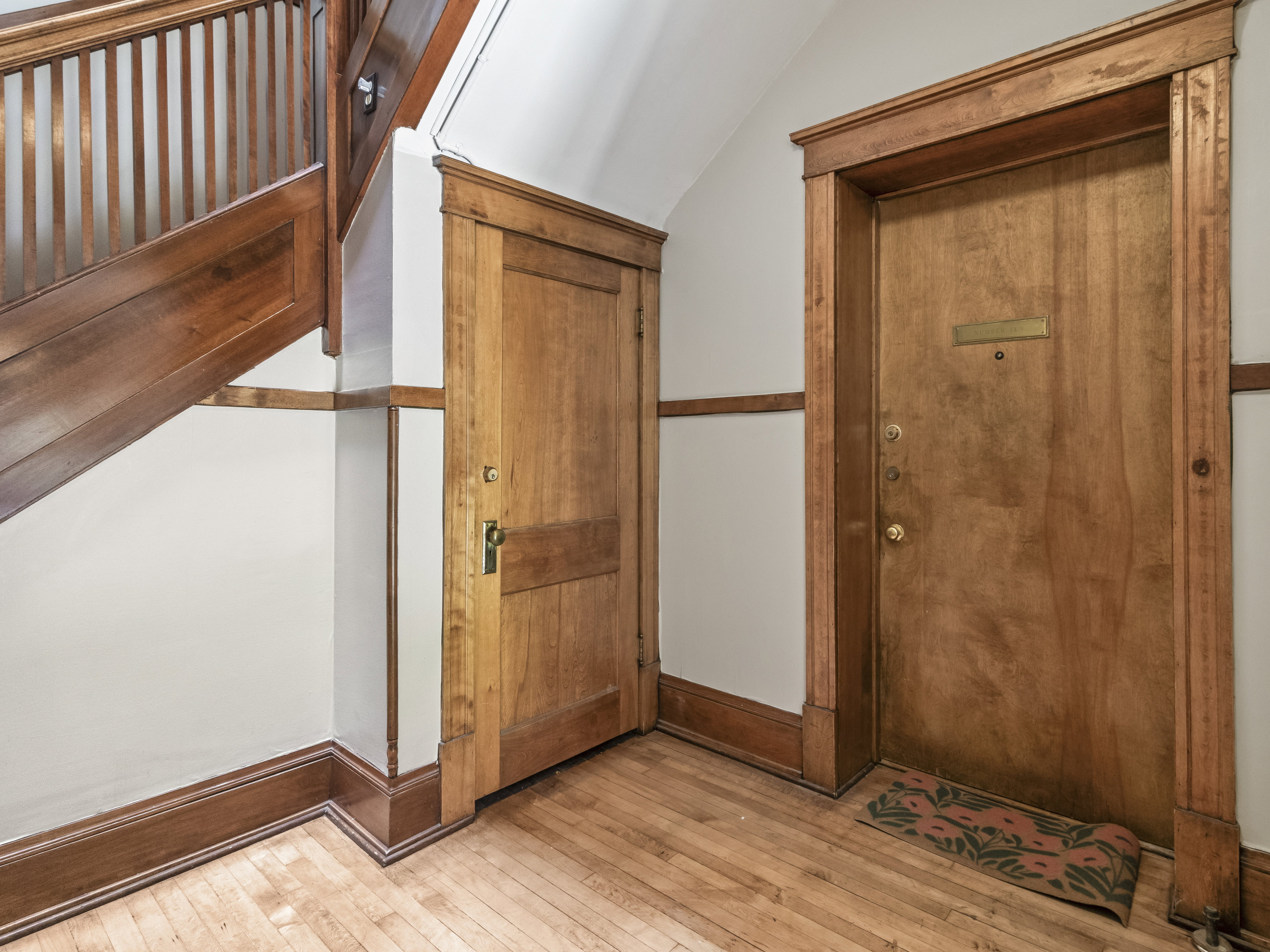 Natural wood-finish staircase with balusters and handrail