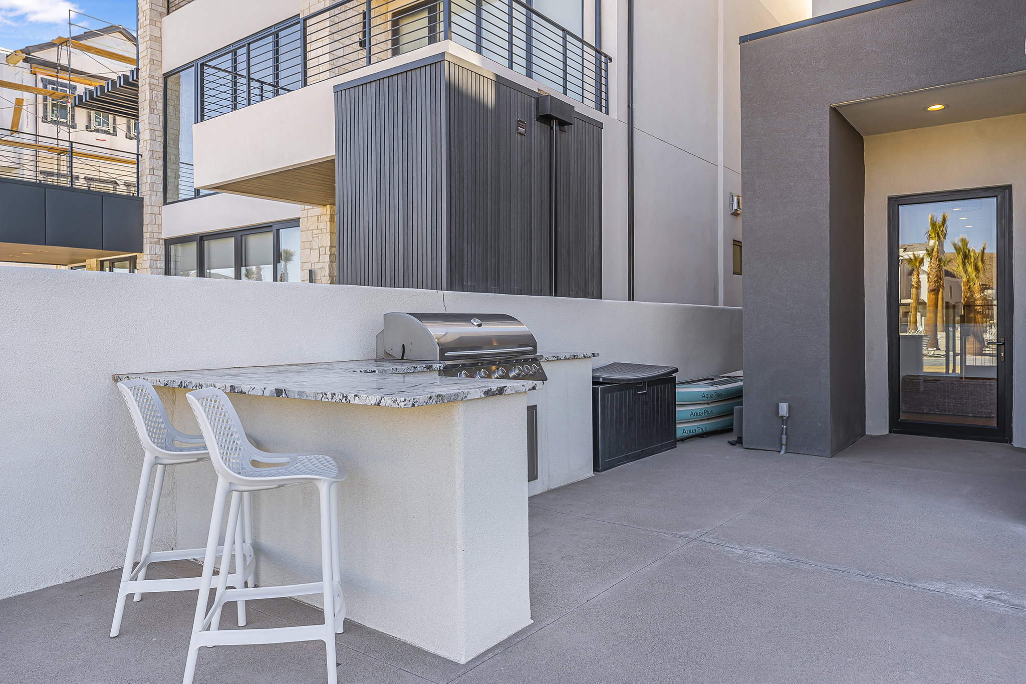 Outdoor patio featuring a built-in barbecue island with a stone countertop and integrated stainless steel grill