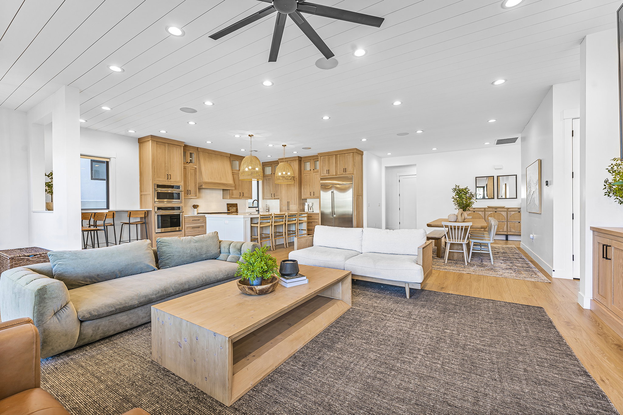 Open-concept living area with shiplap ceiling details and recessed lighting