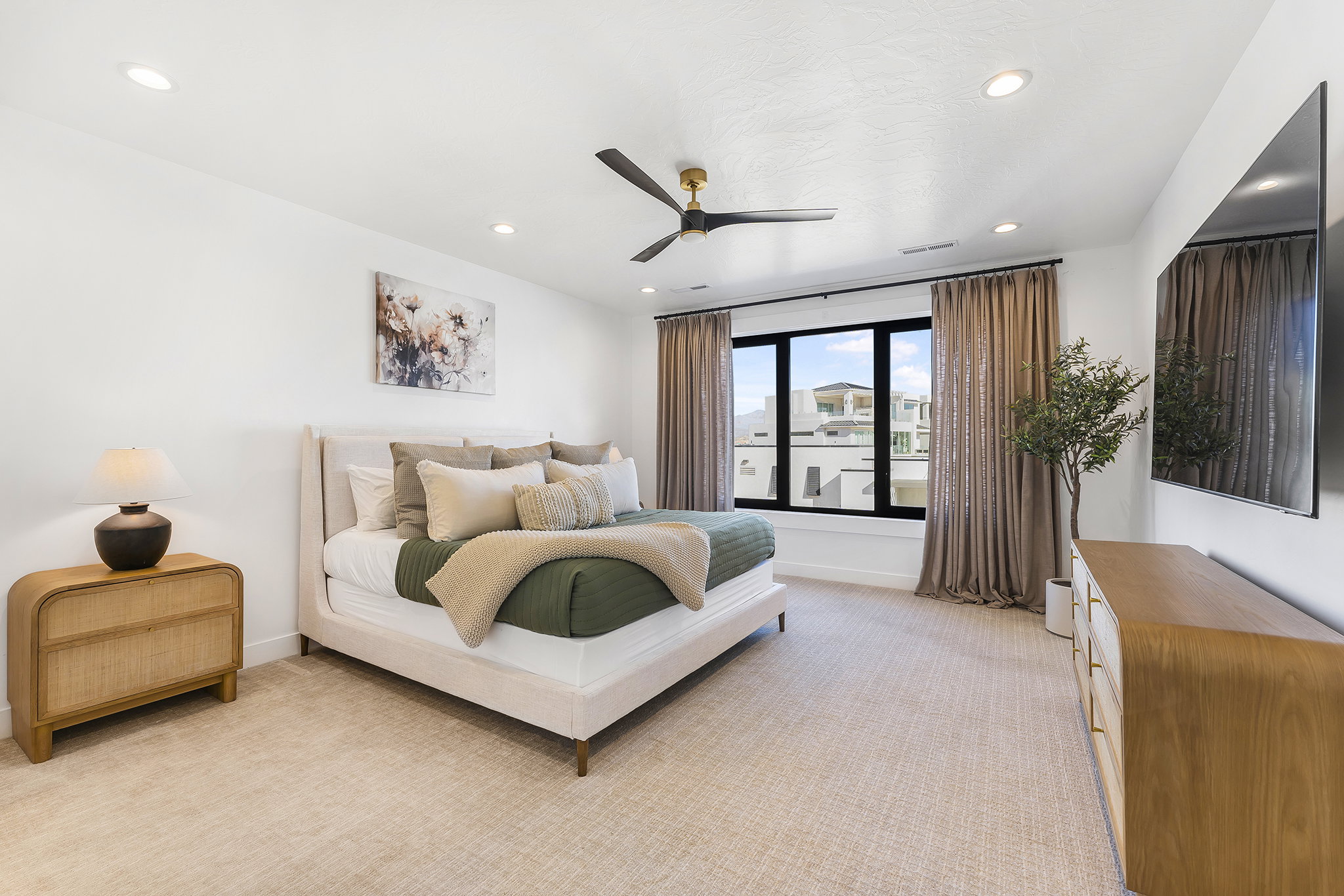 Spacious room featuring neutral carpeting, recessed lighting, and a modern ceiling fan