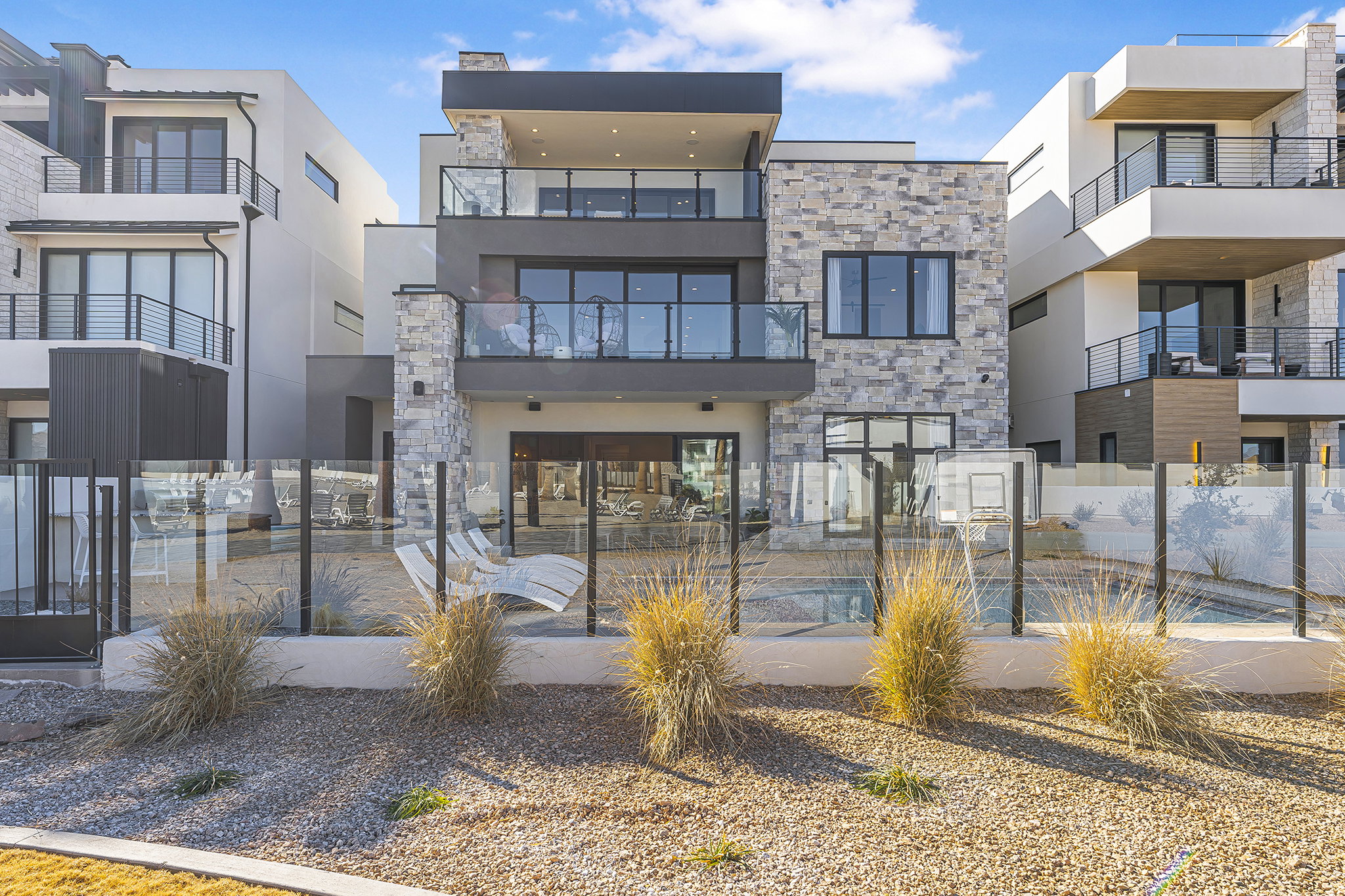 Contemporary multi-story residence featuring stone and stucco exterior finishes