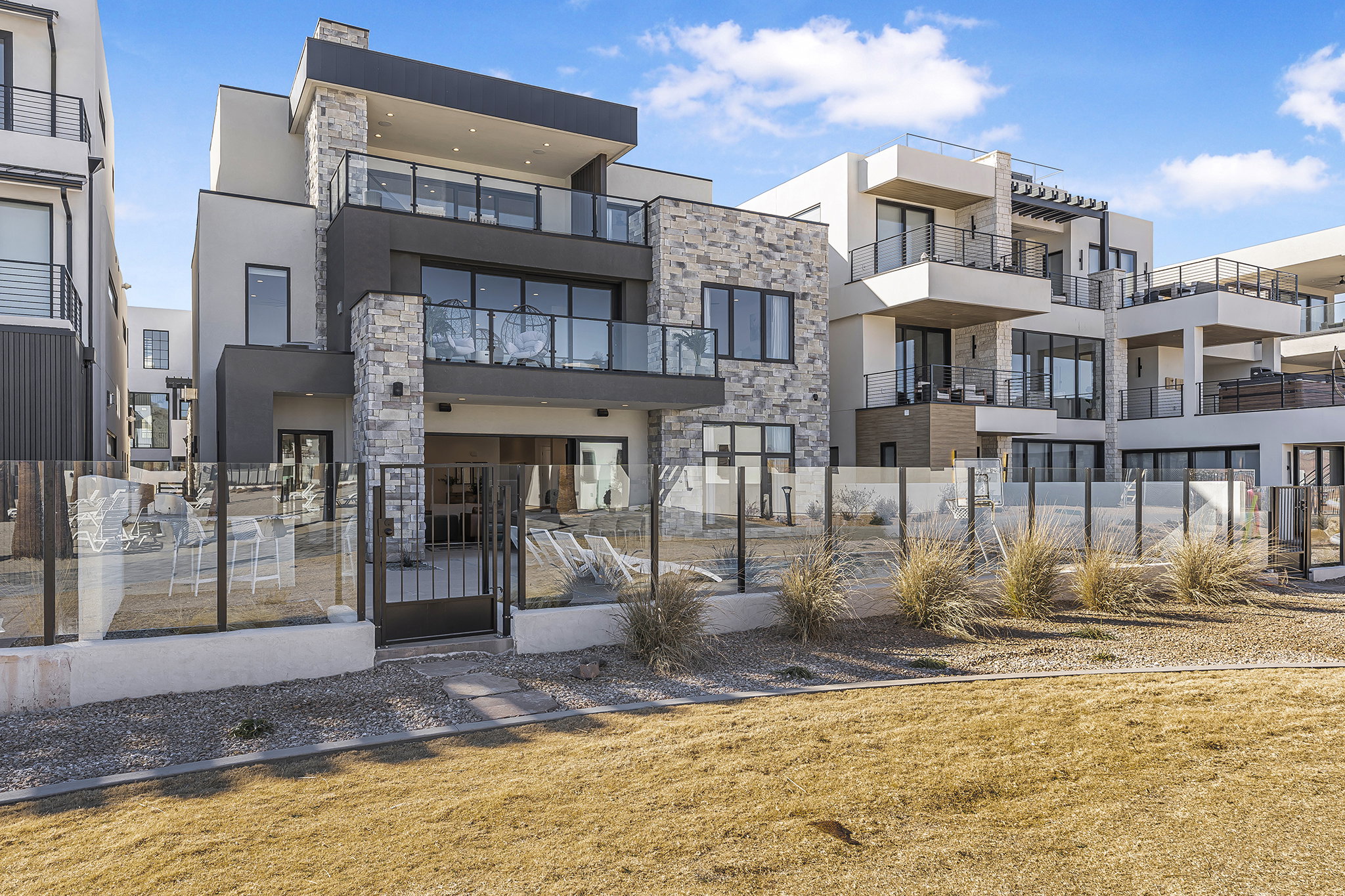 Contemporary multi-story exterior with stone and stucco accents