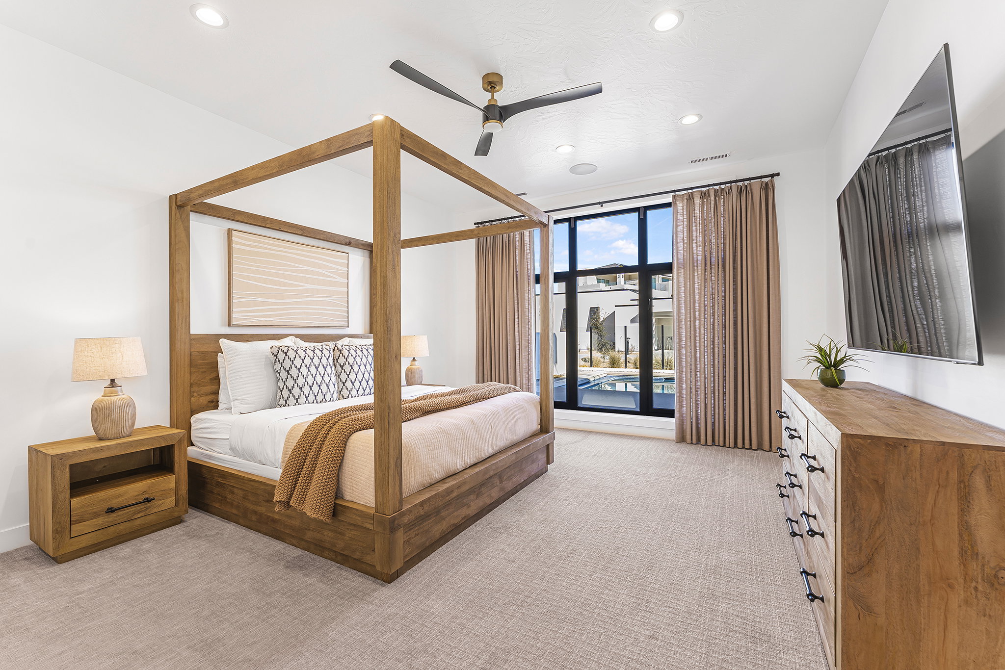 Spacious bedroom featuring light-colored carpeting, recessed lighting, and a contemporary ceiling fan