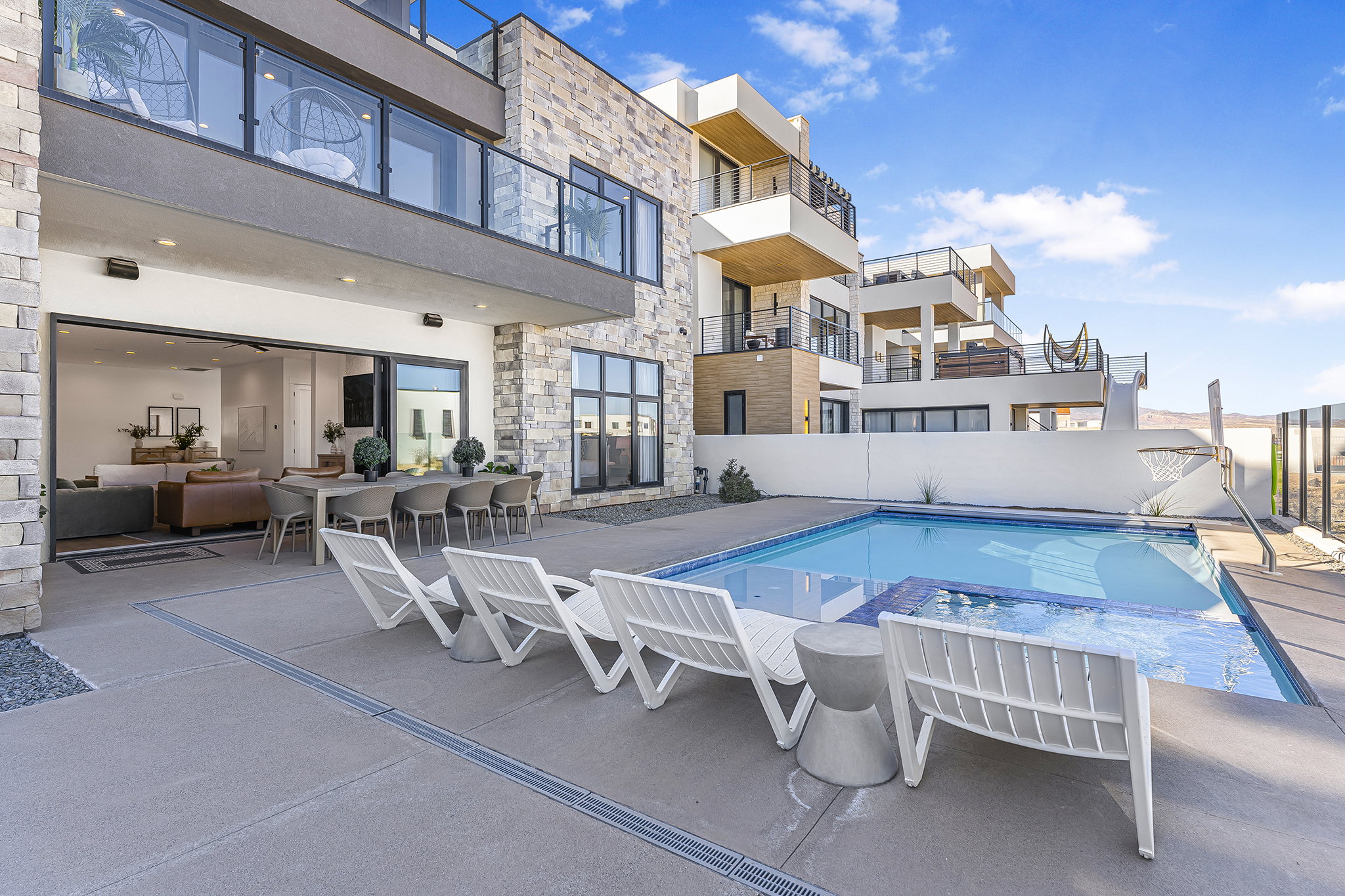 Exterior patio with a swimming pool and integrated spa