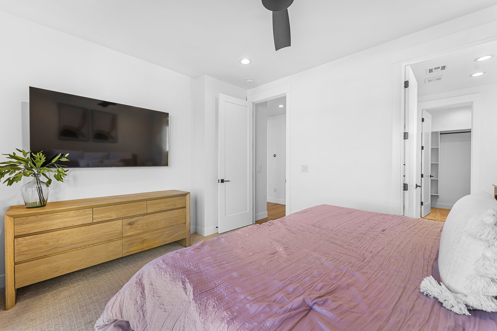 Bedroom featuring white walls and a ceiling fan