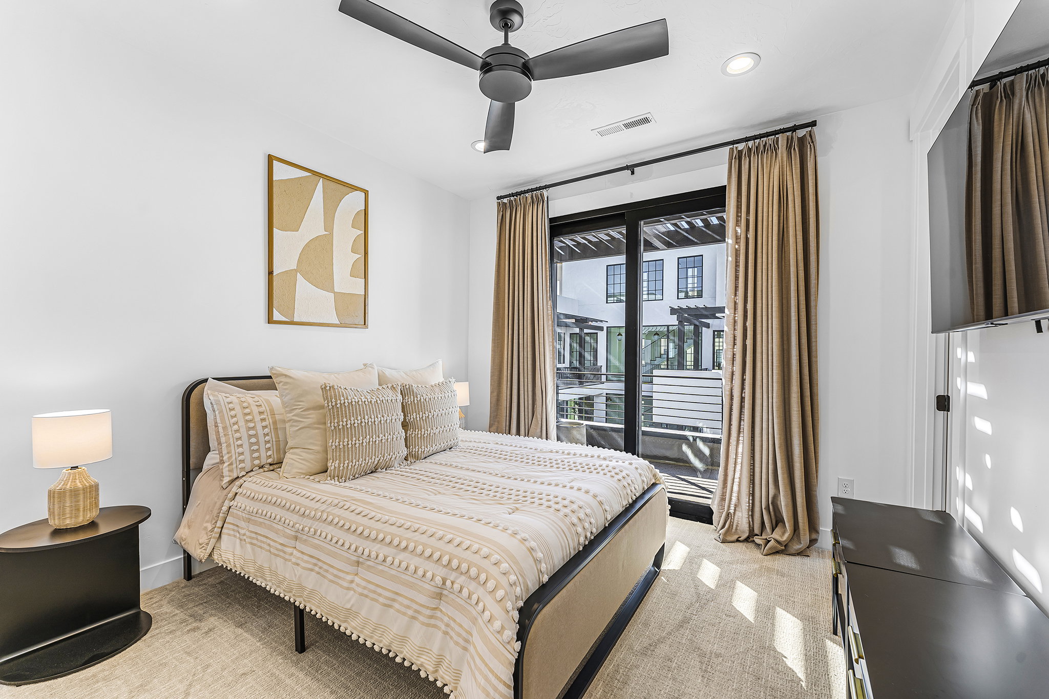 Bright room featuring a ceiling fan, recessed lighting, and a glass-paneled door