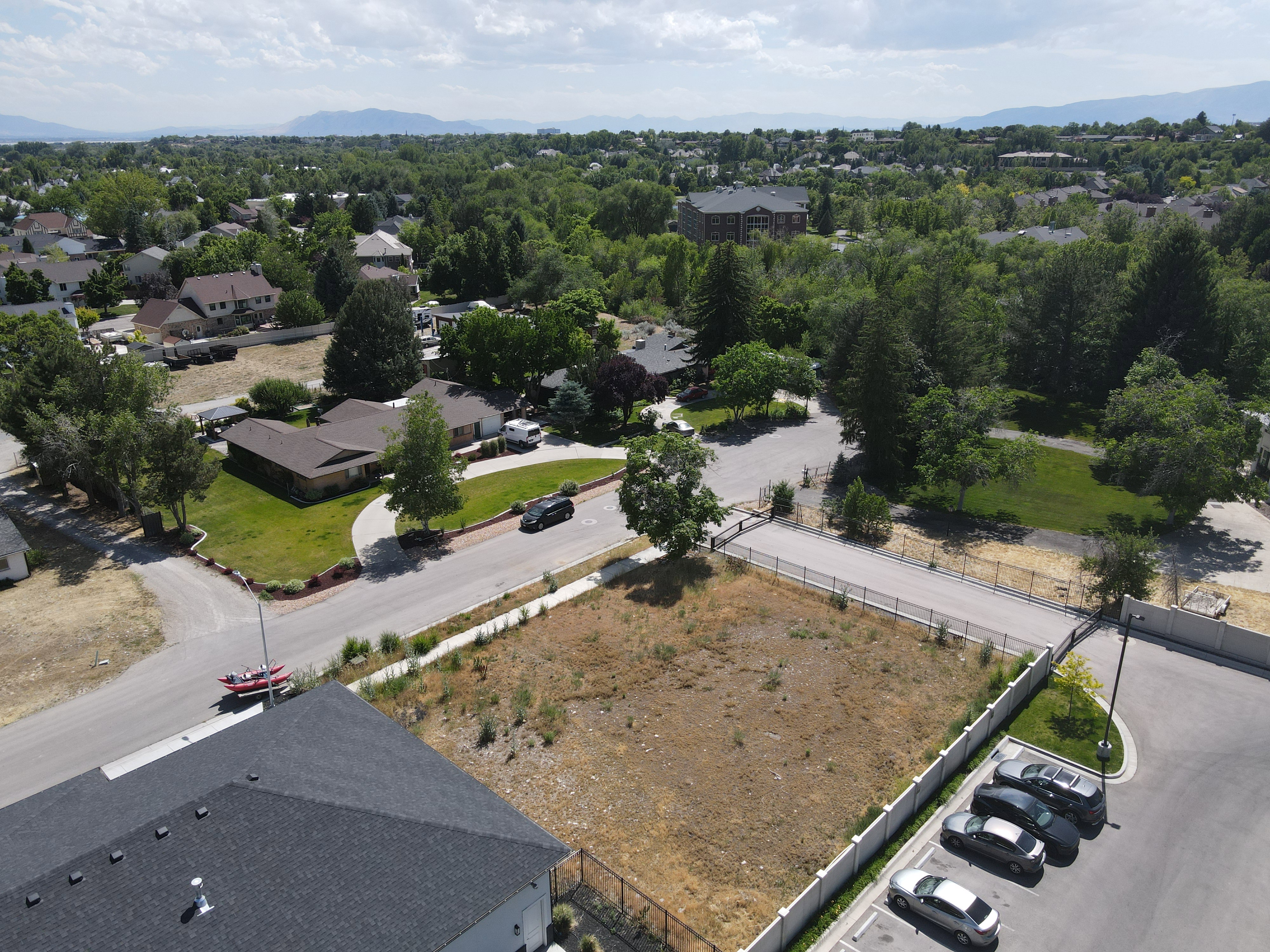 Expansive lot featuring a clear, level building site with mature trees bordering the property