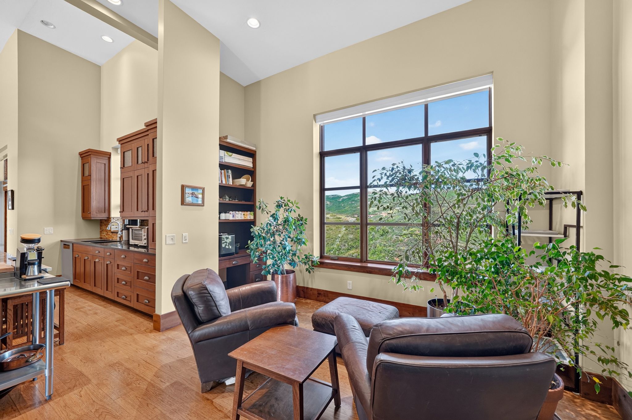 Spacious interior featuring a large window with multiple panes, providing a scenic backdrop of the surrounding landscape