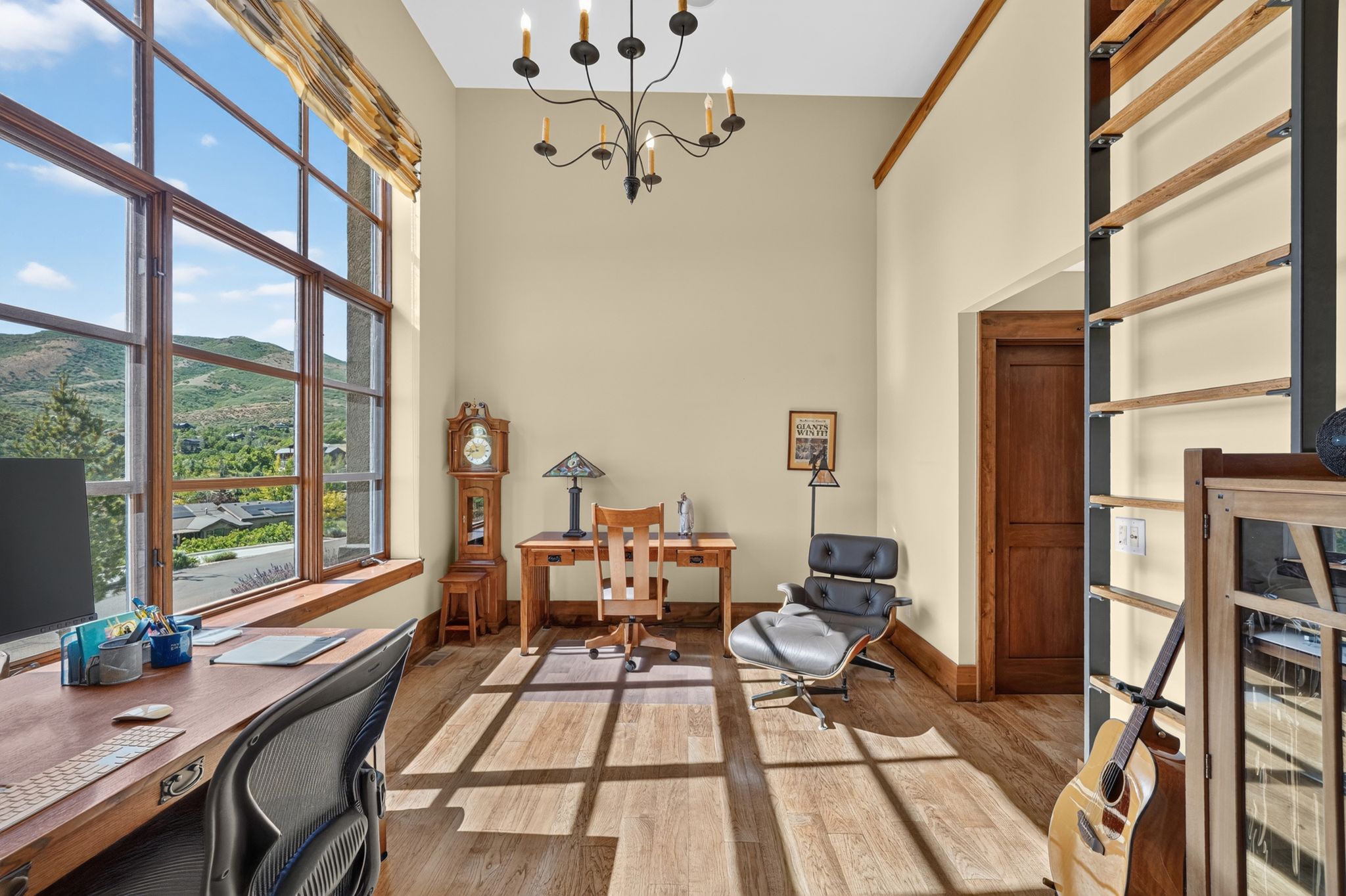 Soaring ceilings with wood-finish flooring and a rustic chandelier