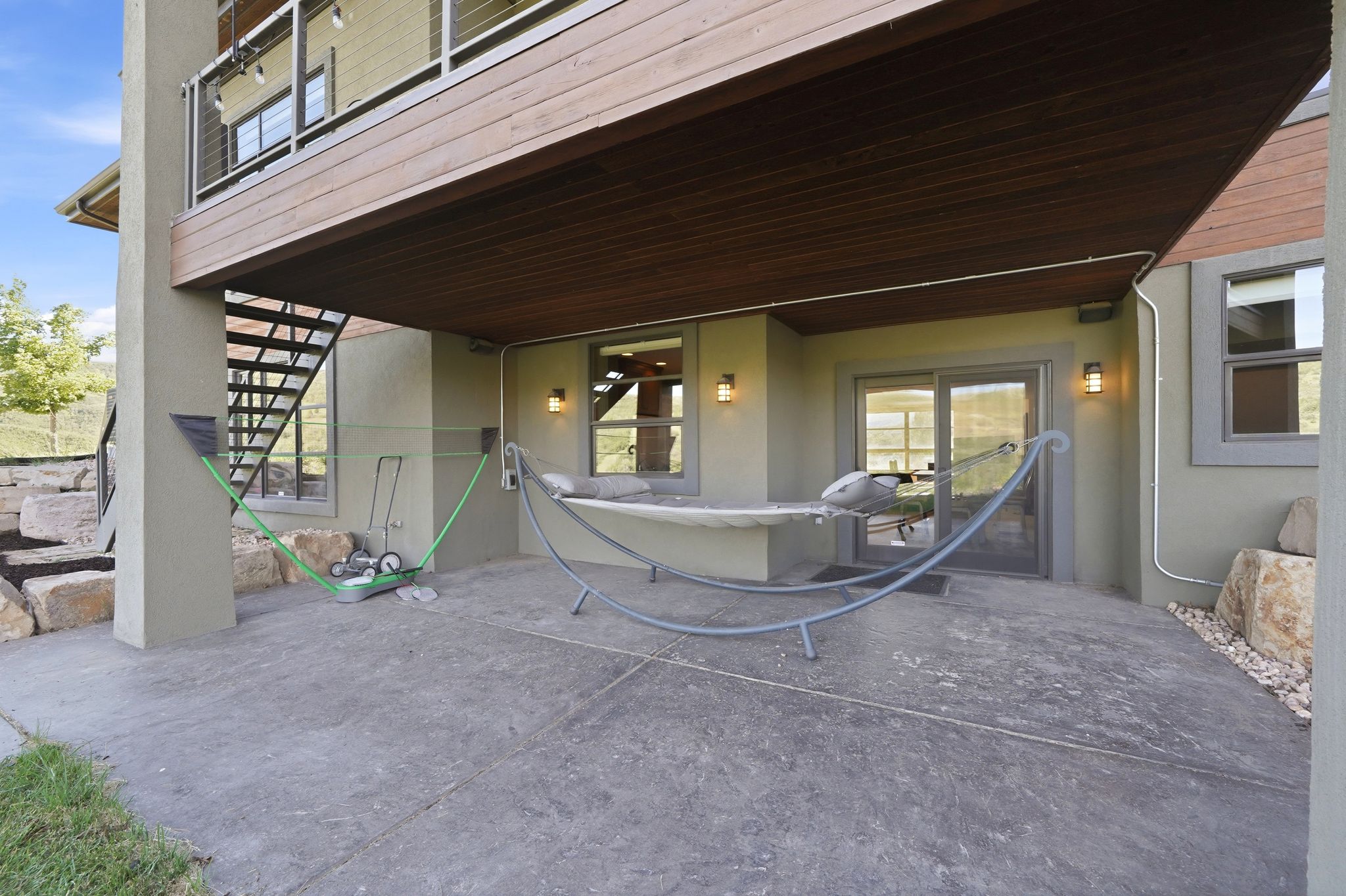 Covered patio featuring a stamped concrete surface, recessed lighting, exterior sconces, and sliding glass door access