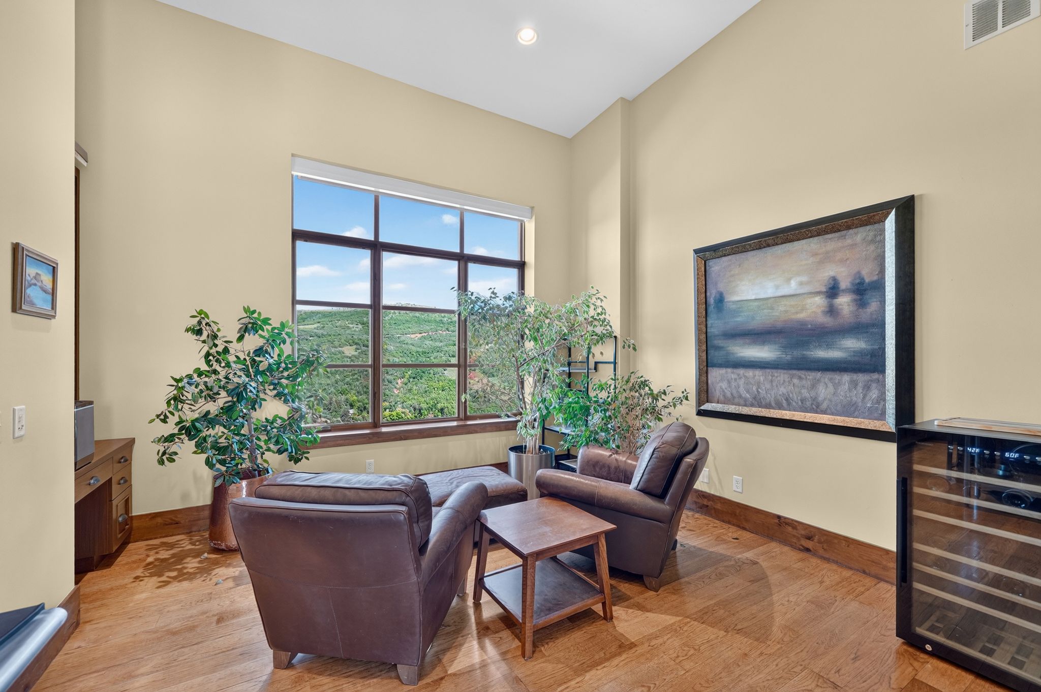 Expansive window wall with a grid pattern, showcasing natural scenery