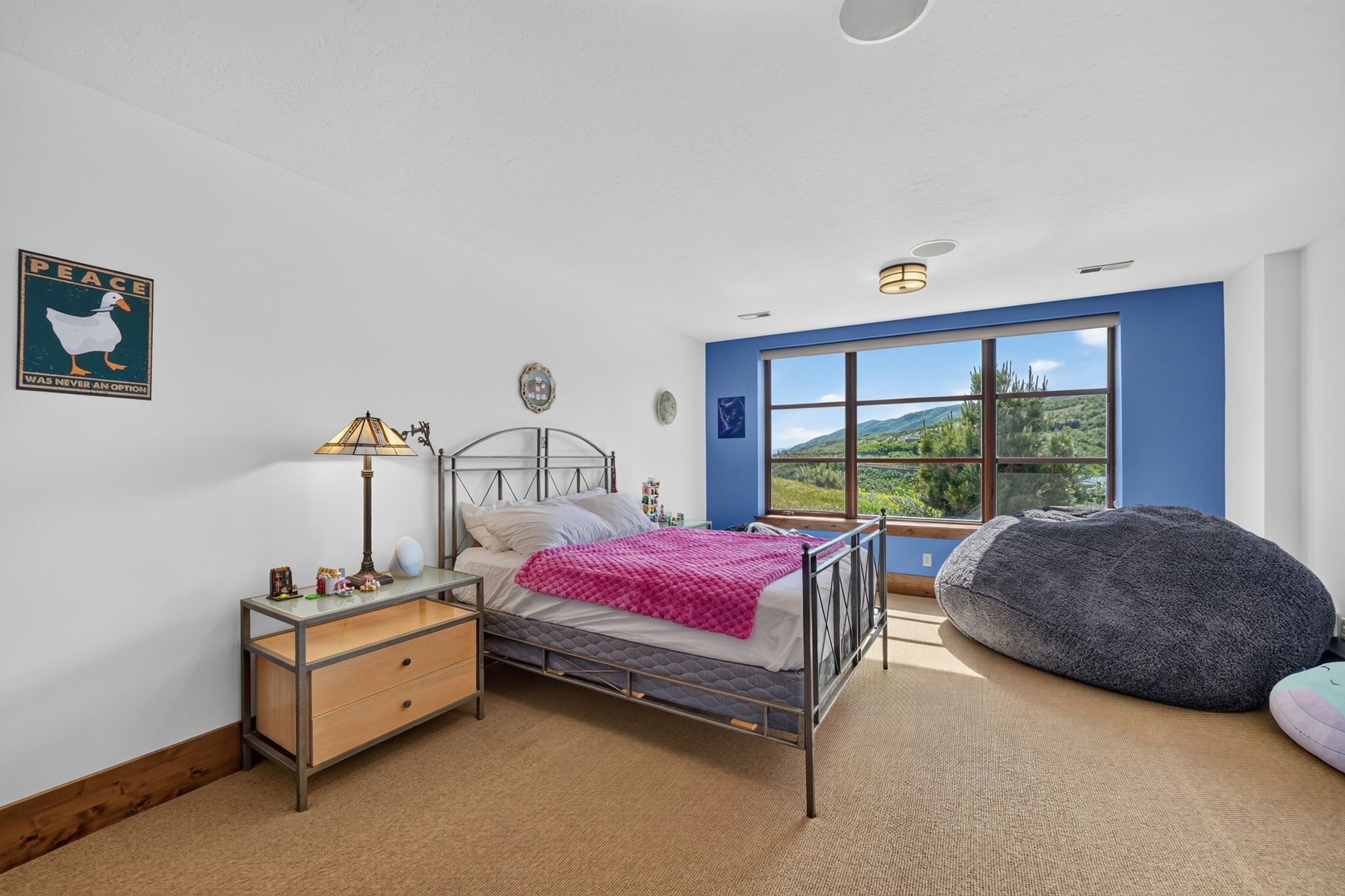 Expansive window offering distant mountain and tree-lined scenery