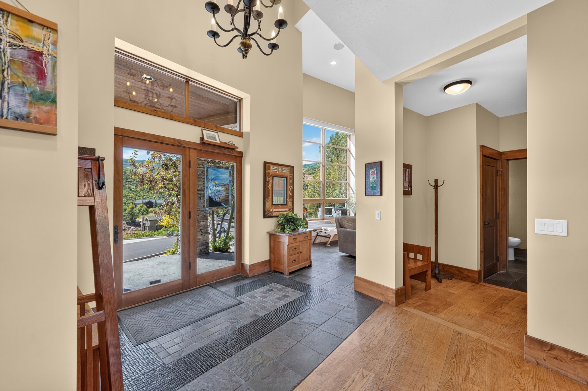 Grand entry featuring double wood-frame glass doors with transom windows