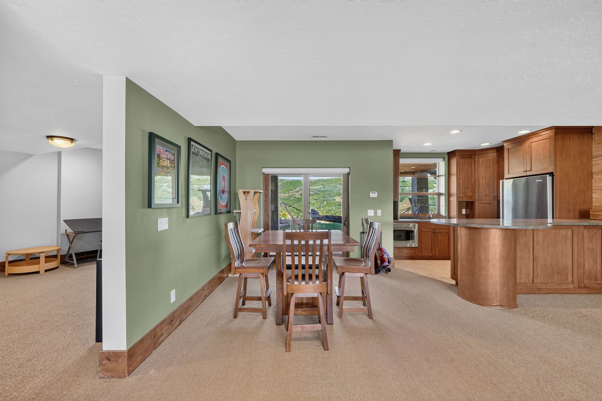 Kitchenette featuring wood cabinetry, stainless steel refrigerator, and built-in microwave