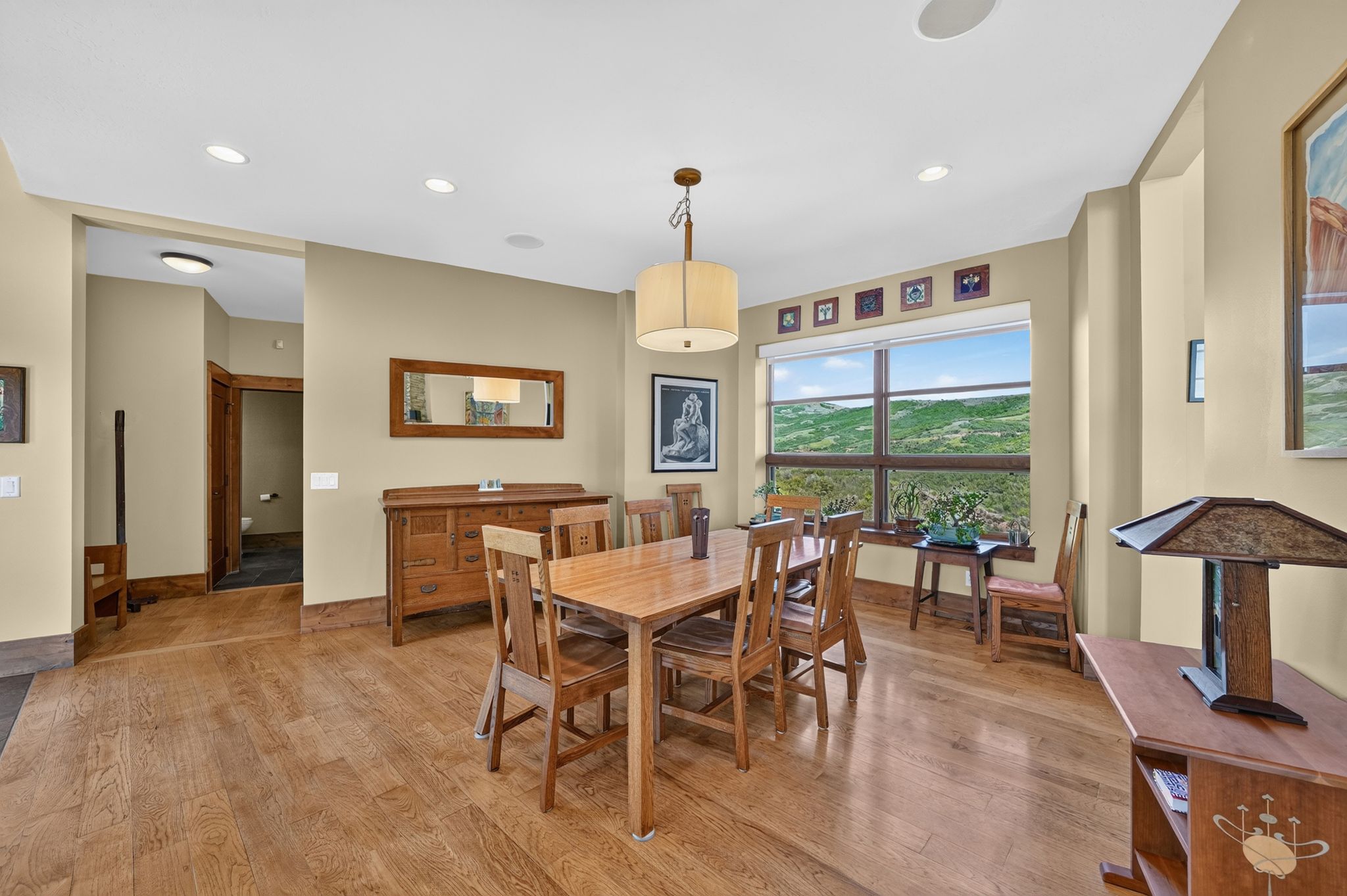 Dining area with wood-finish flooring, recessed lighting, and a chandelier-style fixture