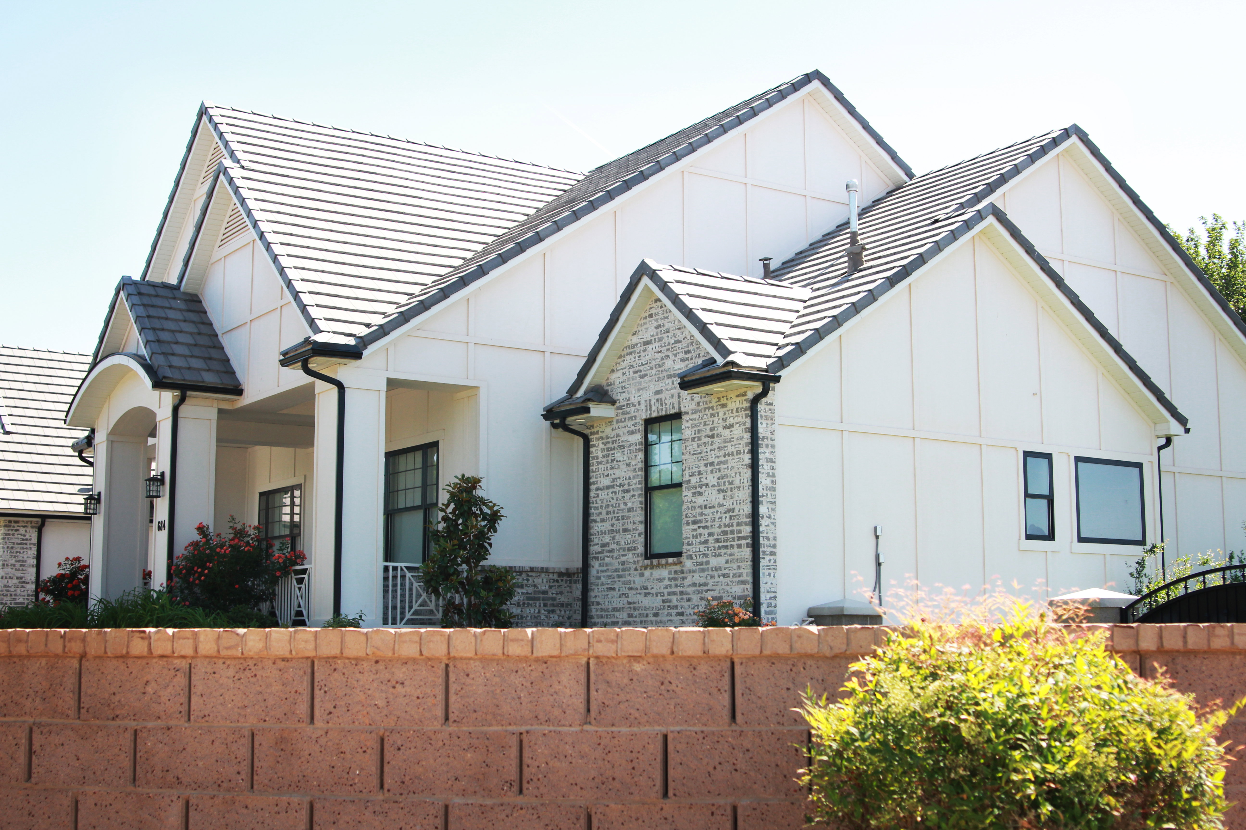 Modern farmhouse exterior featuring white board and batten siding with contrasting dark trim