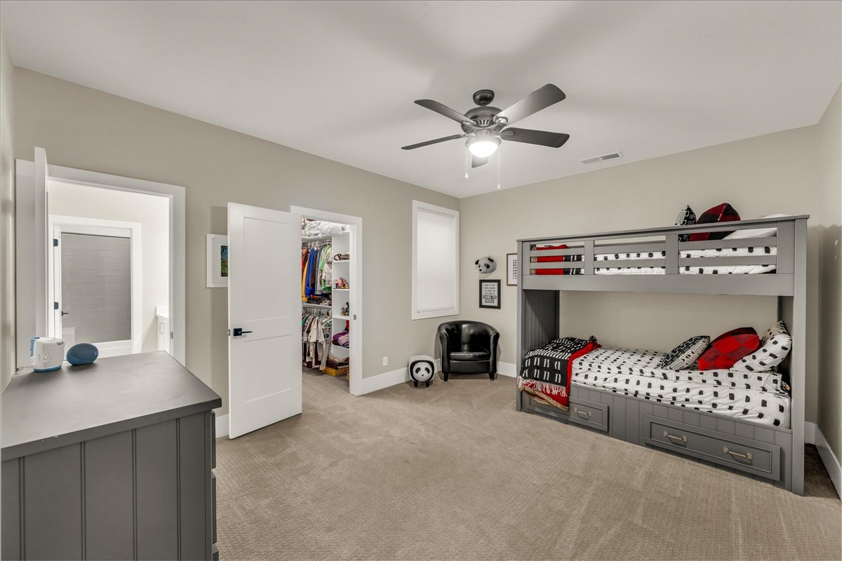 Bedroom with neutral carpet and light-toned walls