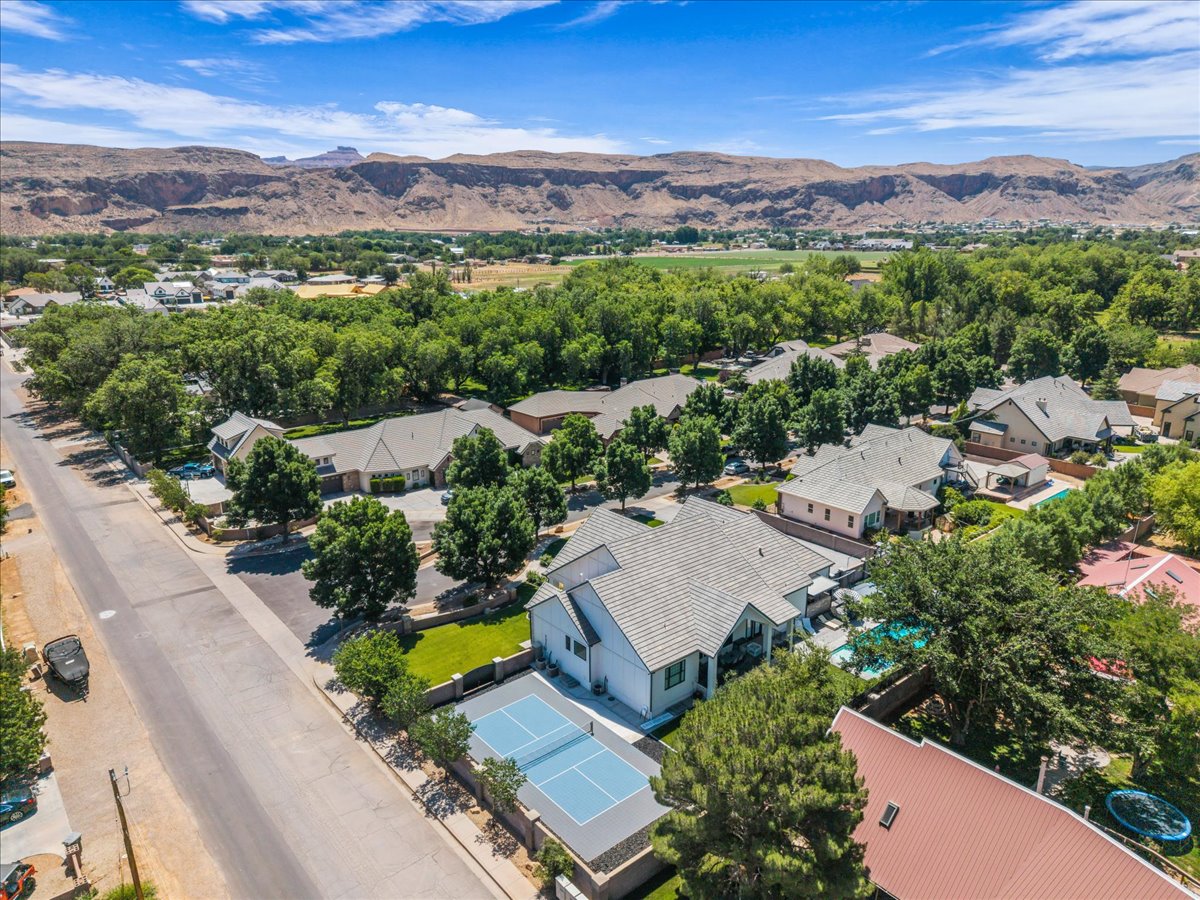 Aerial perspective highlighting the property with a private sport court