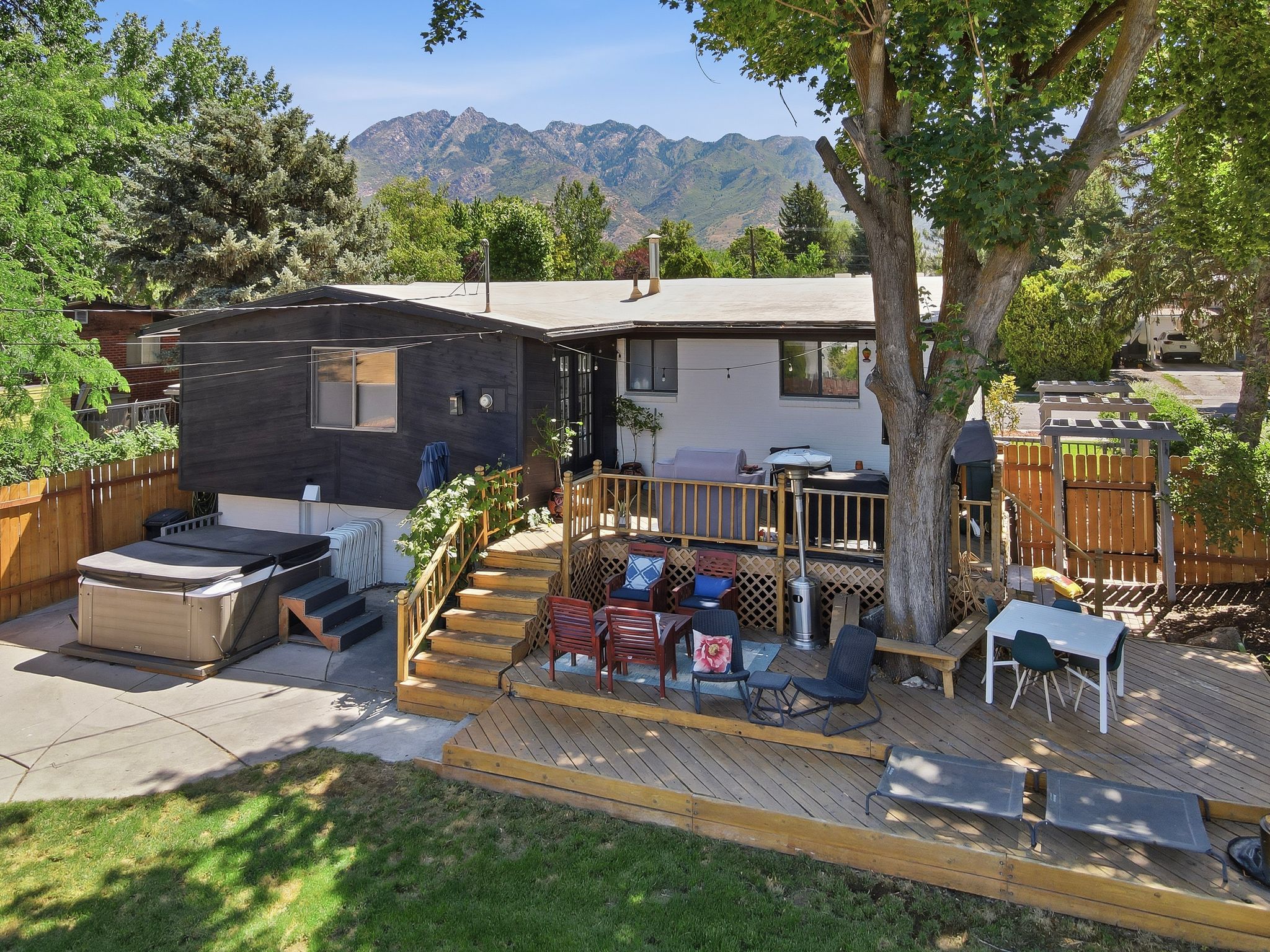 Multi-level wood deck with a built-in bench, offering ample outdoor entertaining space