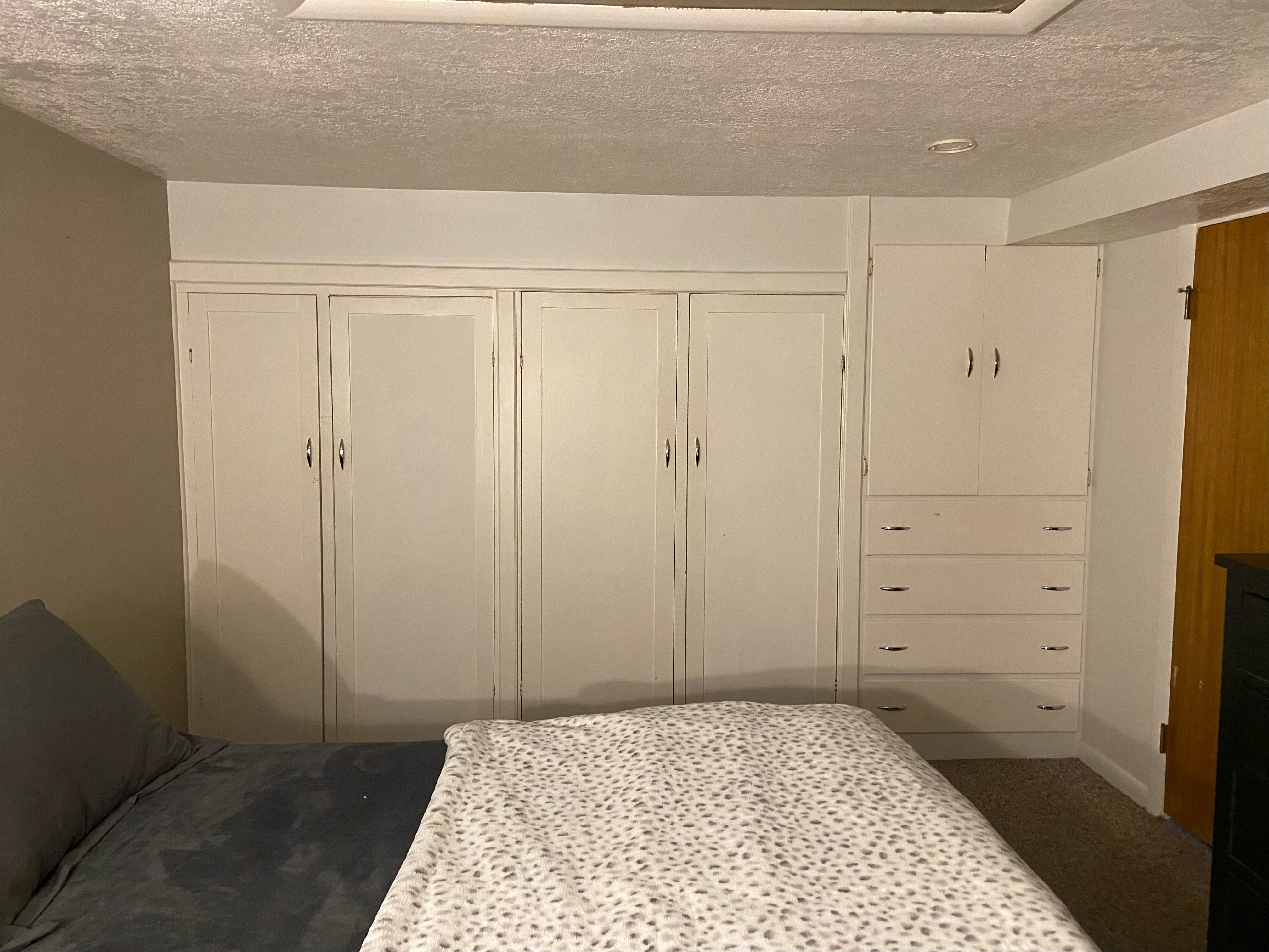 Built-in cabinetry featuring white shaker-style doors and chrome hardware