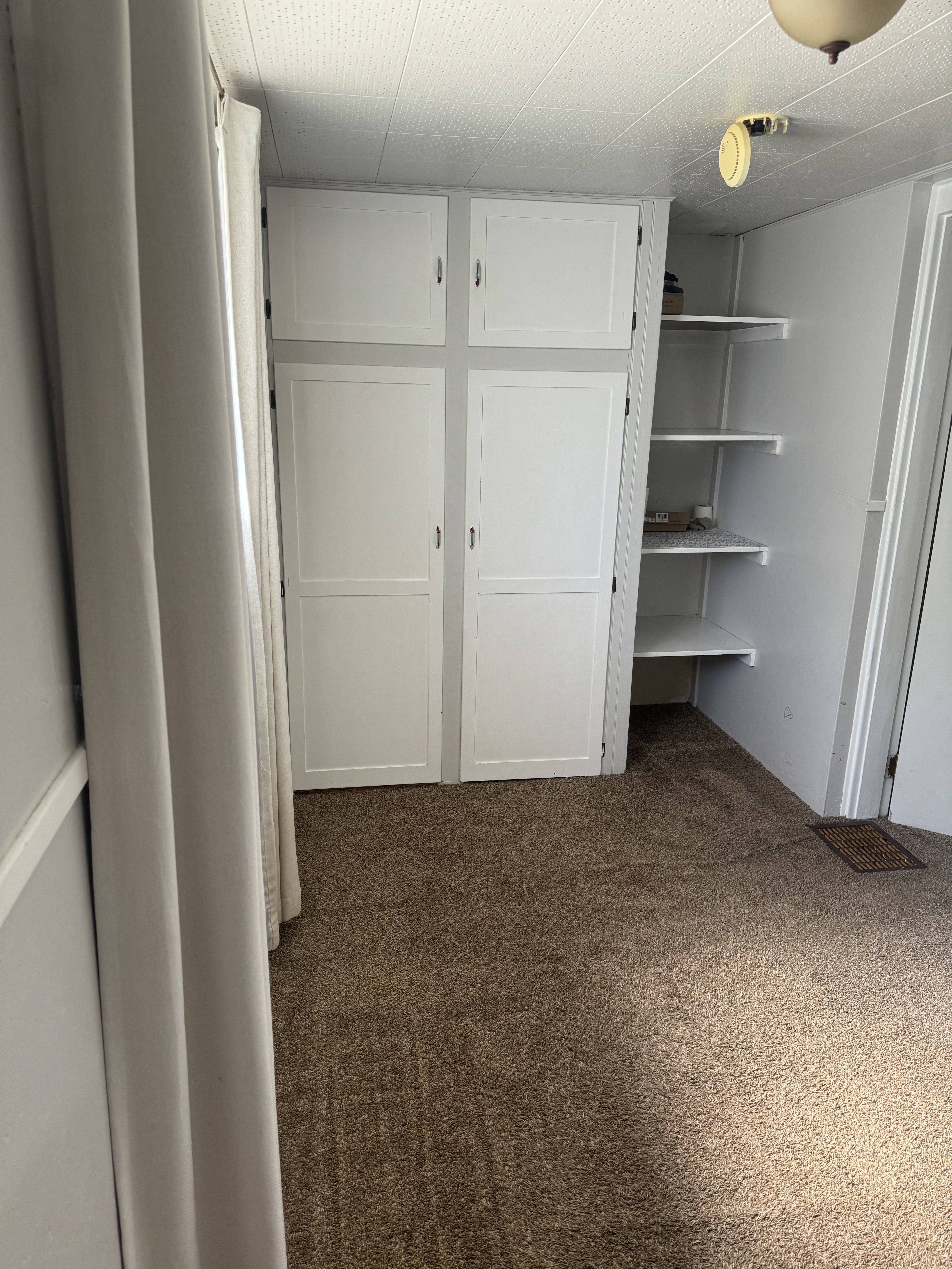 Built-in white cabinetry providing integrated storage, complemented by open shelving