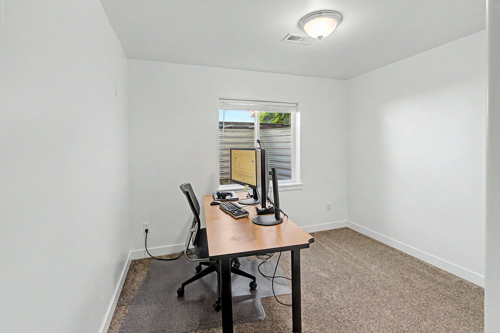 Bright room with neutral carpet flooring and white walls