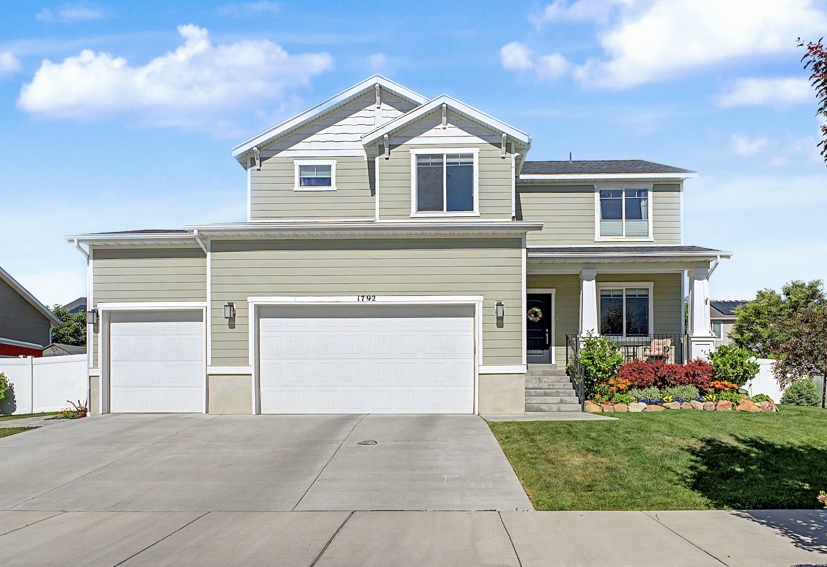 Two-story residence featuring light green siding and white trim accents