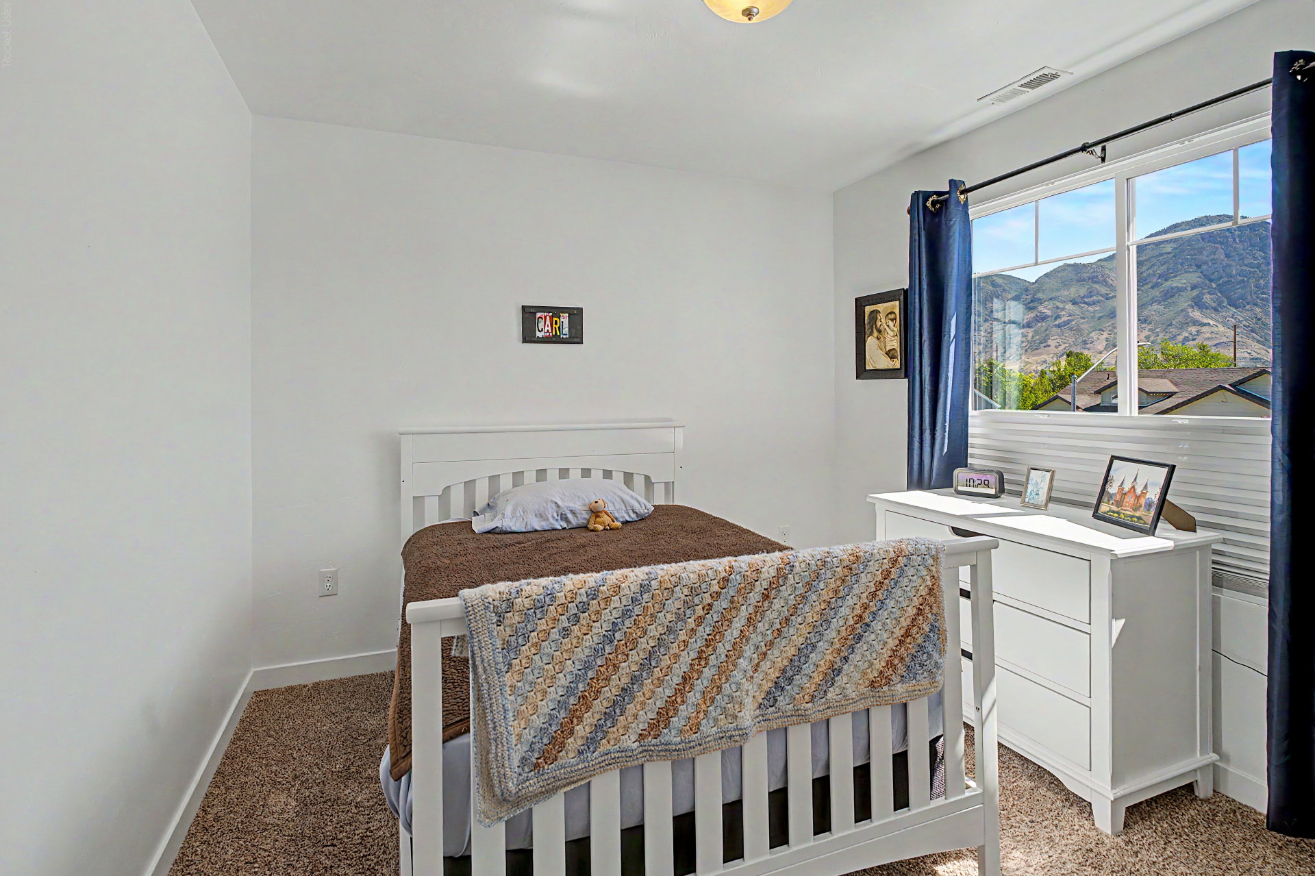 Room featuring white walls and neutral-toned carpeting