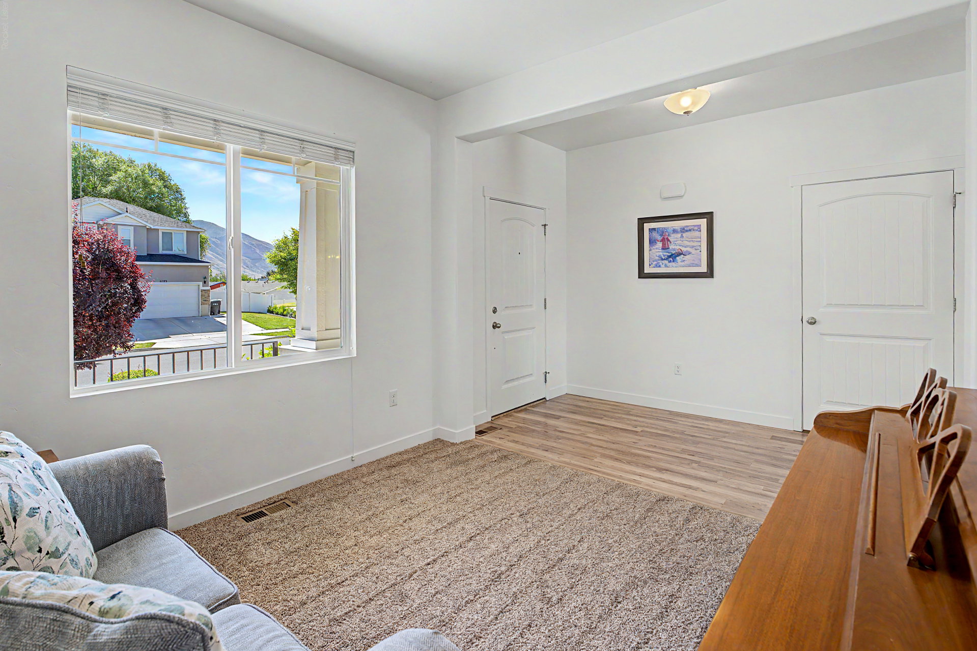 Bright interior space featuring a large window, white walls, and a recessed ceiling light fixture