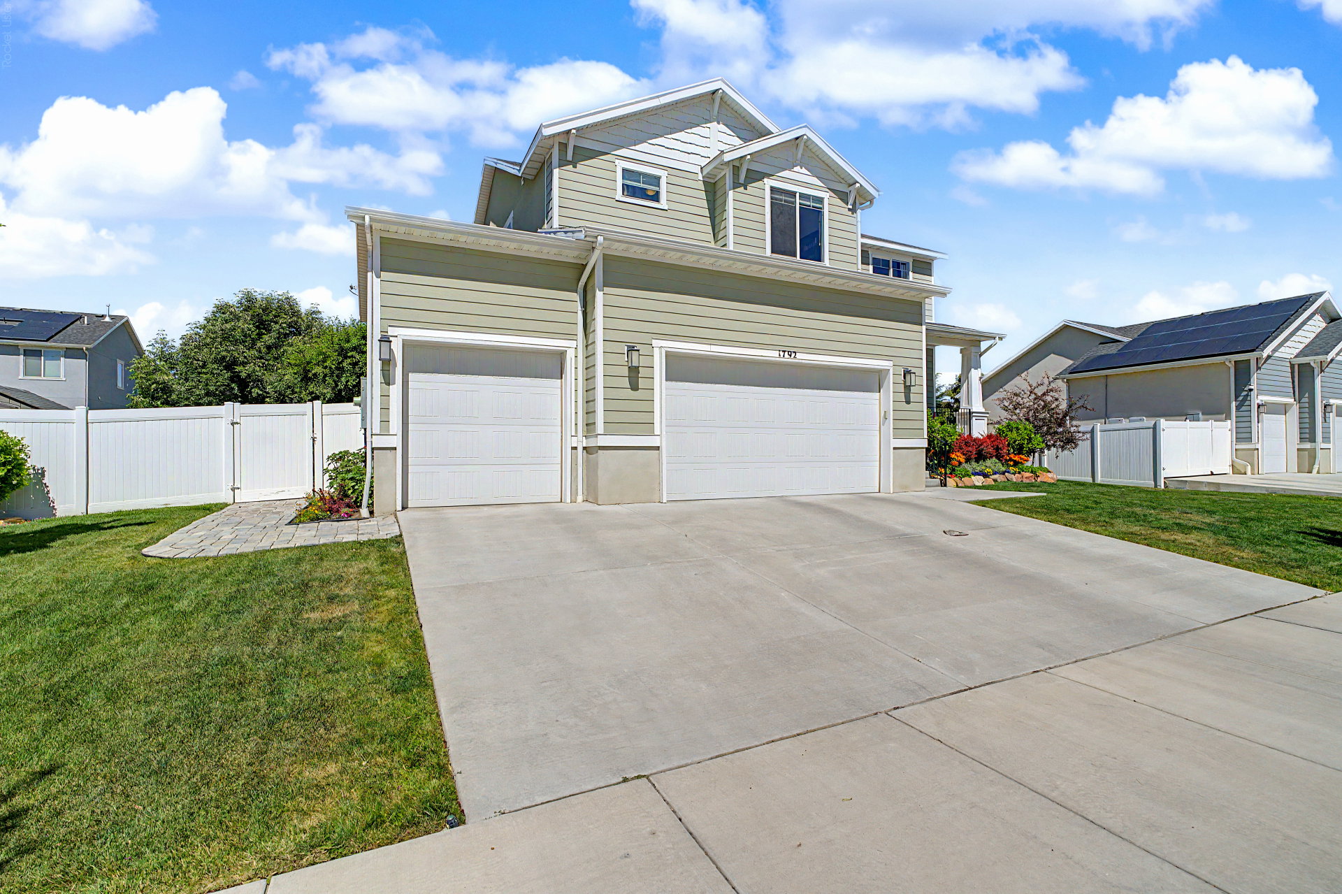 Two-story property featuring light green siding and white trim