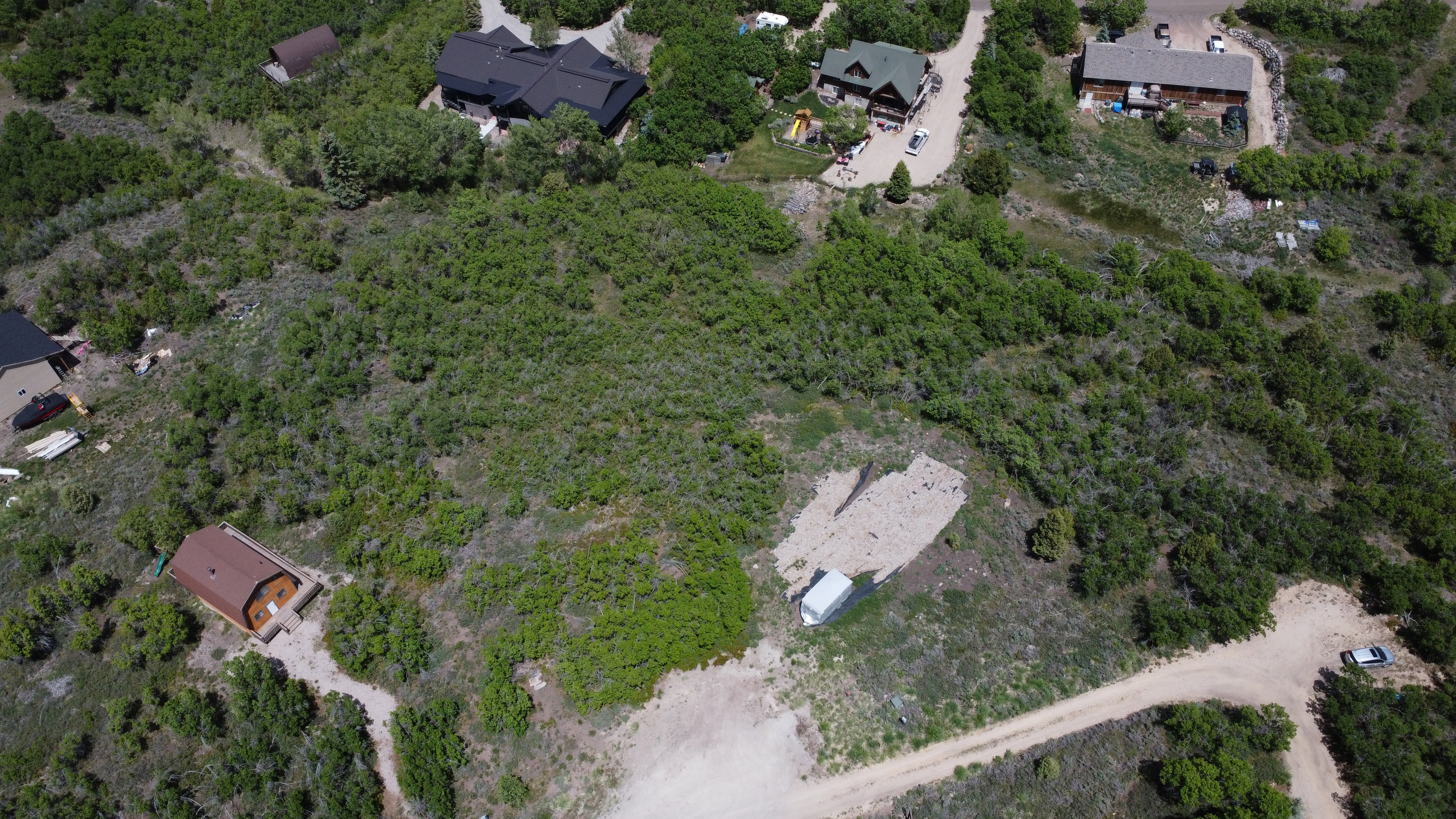 Expansive undeveloped land parcel featuring natural foliage and a partial clearing